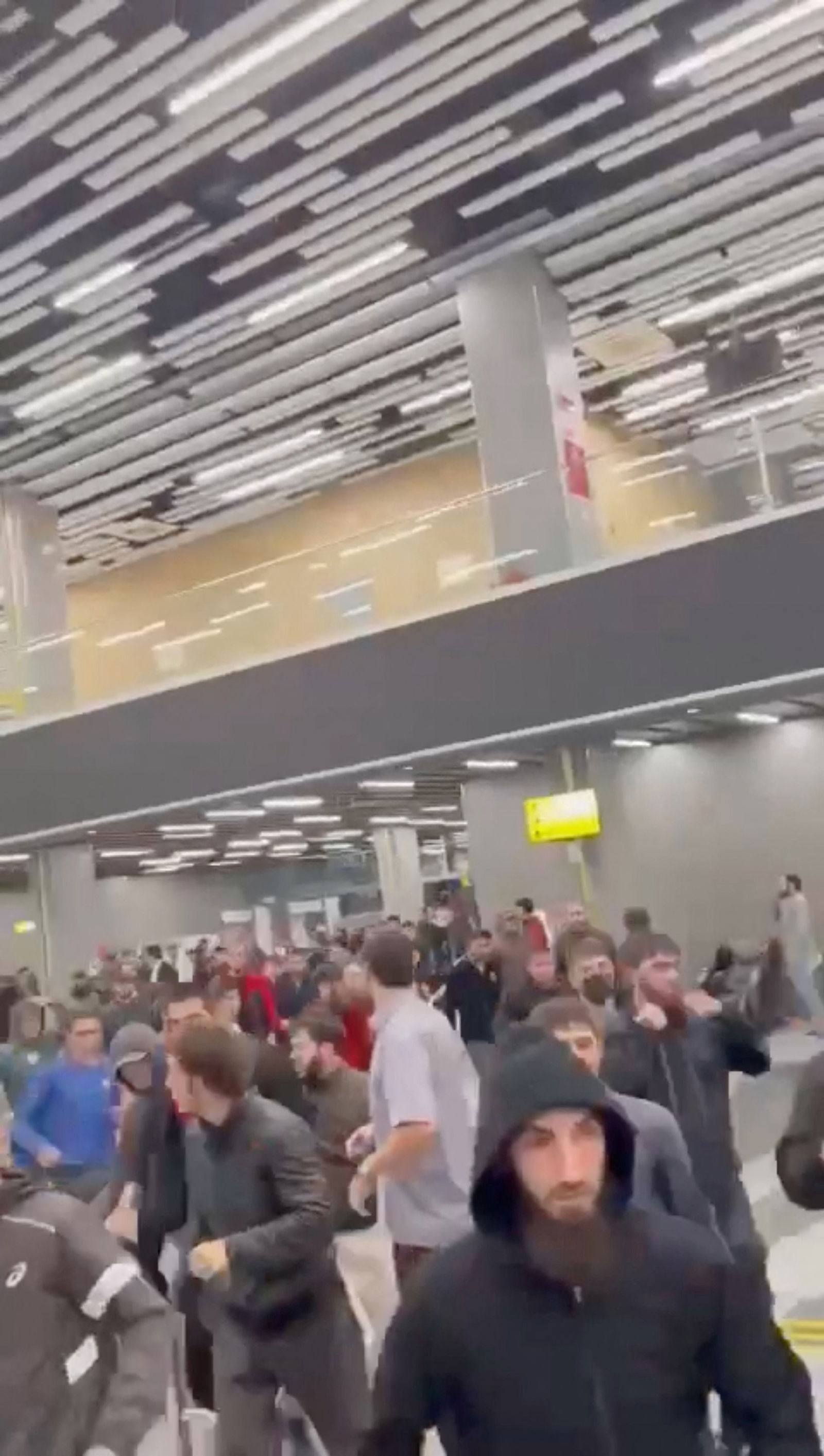 People walk as Pro-Palestinian protesters storm an airport building, in Makhachkala, Russia, October 29, 2023, in this screengrab taken from a video obtained by Reuters. 