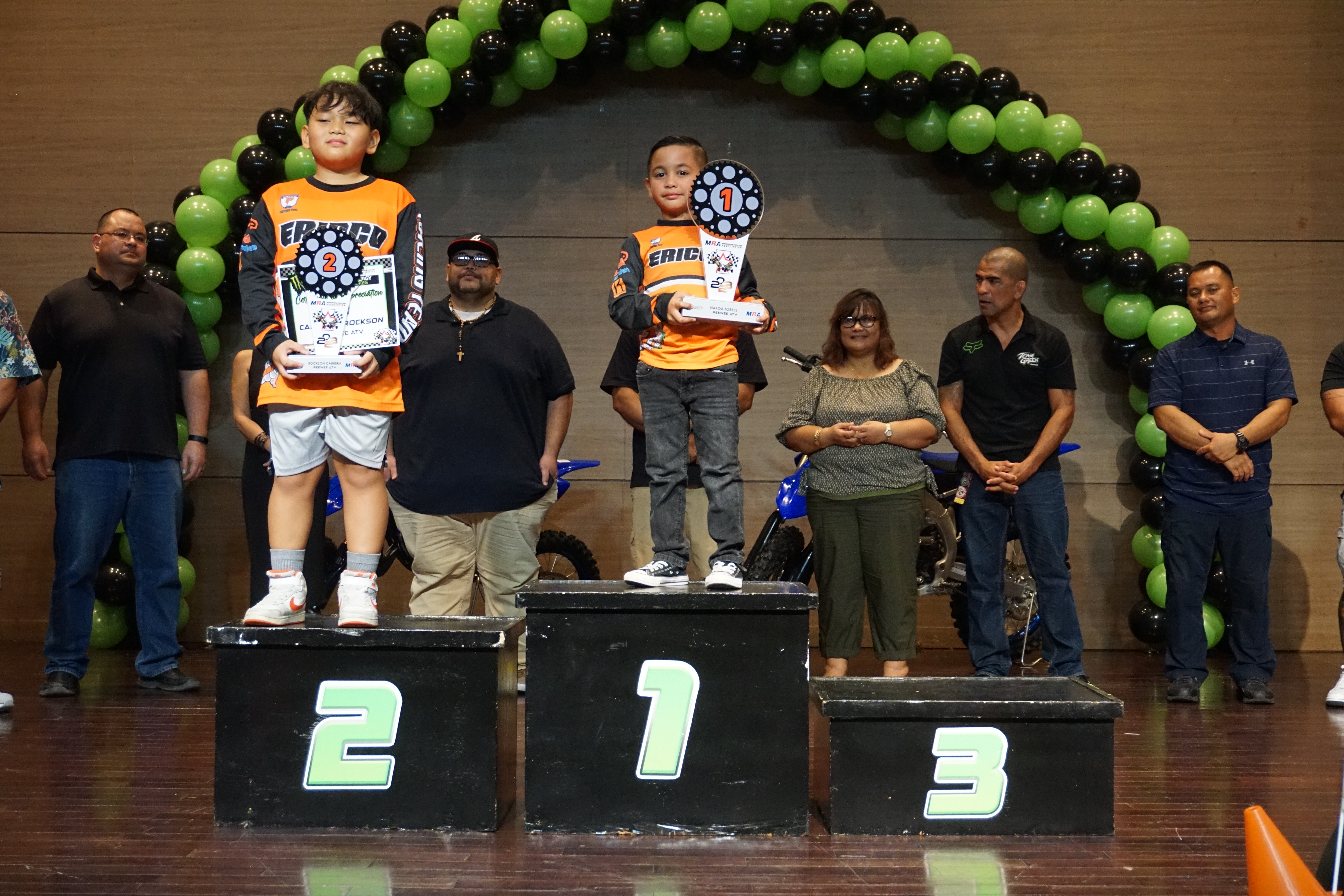 Nakoa Torres, center, and Rockson Cabrera pose for a photo with their trophies in the Peewee ATV class of the 2023 MRA Monster Energy Points Race Series during the awards ceremony on Sept. 30 at the Saipan World Resort Taga Hall.