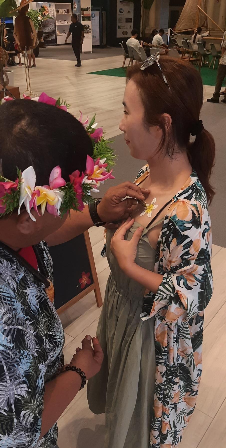 Brian Rueben decorates a visitor with banana stalk painting on Sept. 28, 2023, at the Marianas Experience at T Galleria in Saipan.