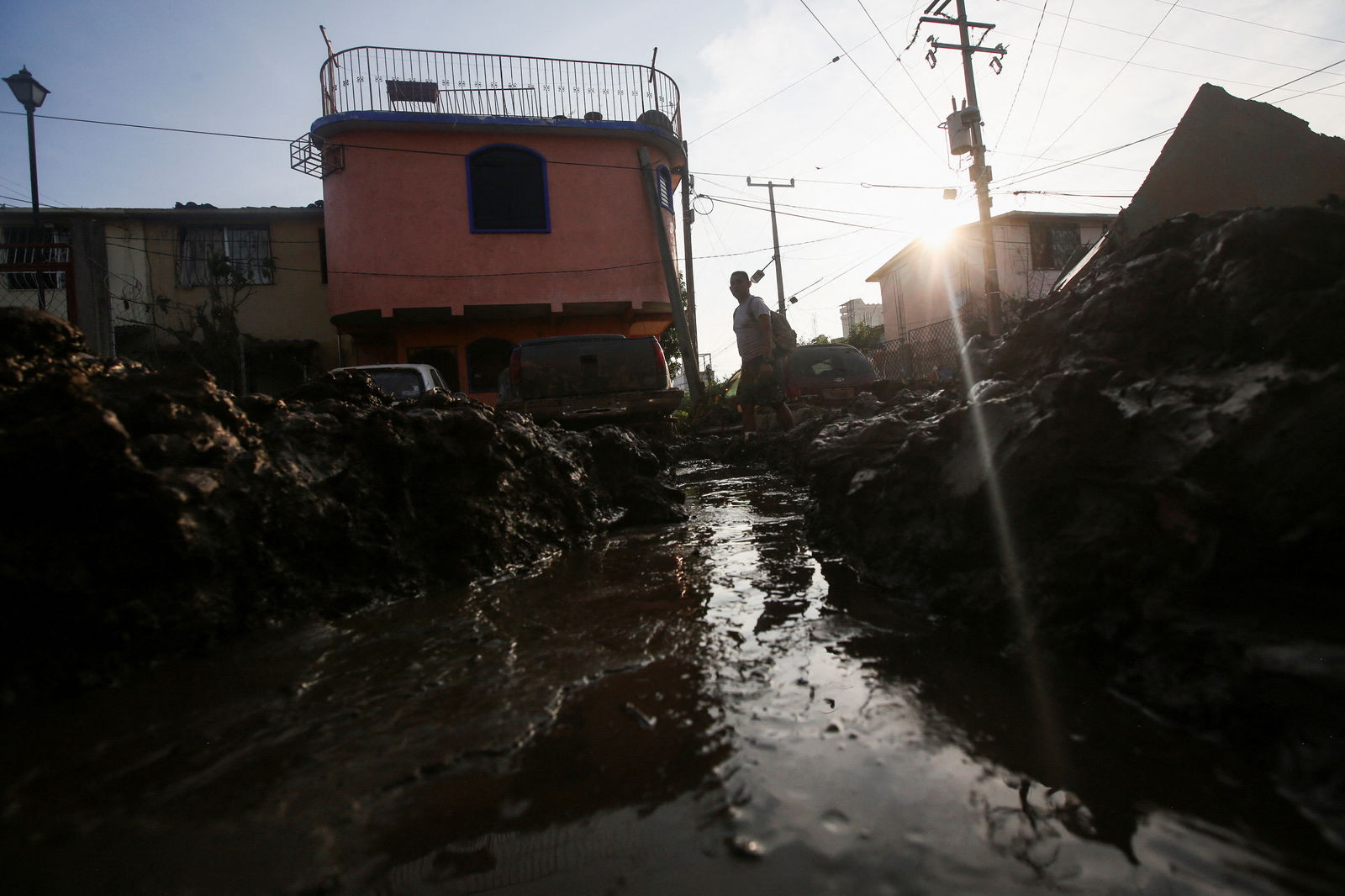 A man walks in the mud, in the aftermath of Hurricane Otis, in Acapulco, Mexico, October 29, 2023. 