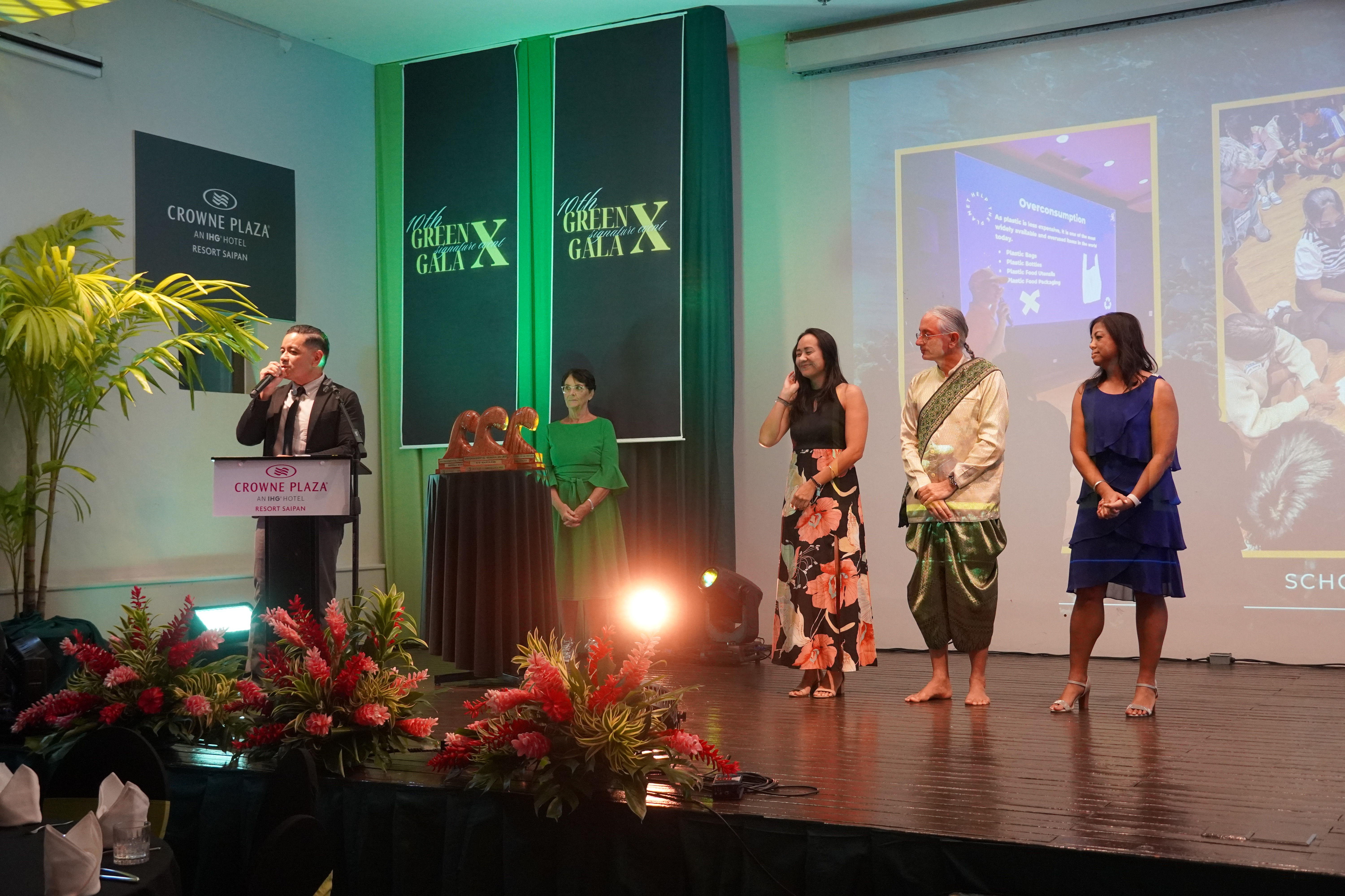 Frankie Eliptico delivers his remarks while the rest of the MINA board members stand on stage.