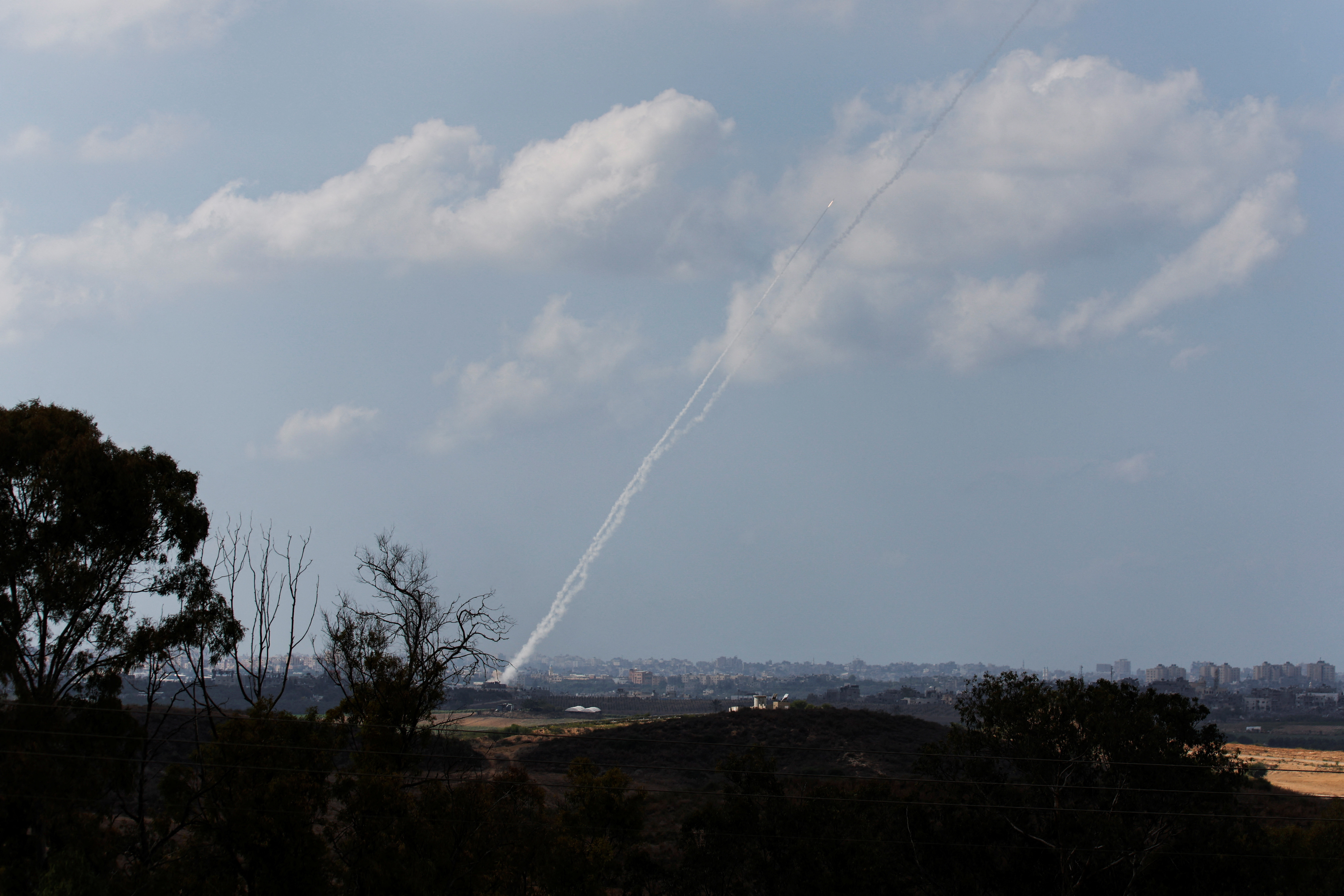 A view shows a rocket being launched from the Gaza Strip into Israel, as seen from Israel's border in southern Israel October 15, 2023. 