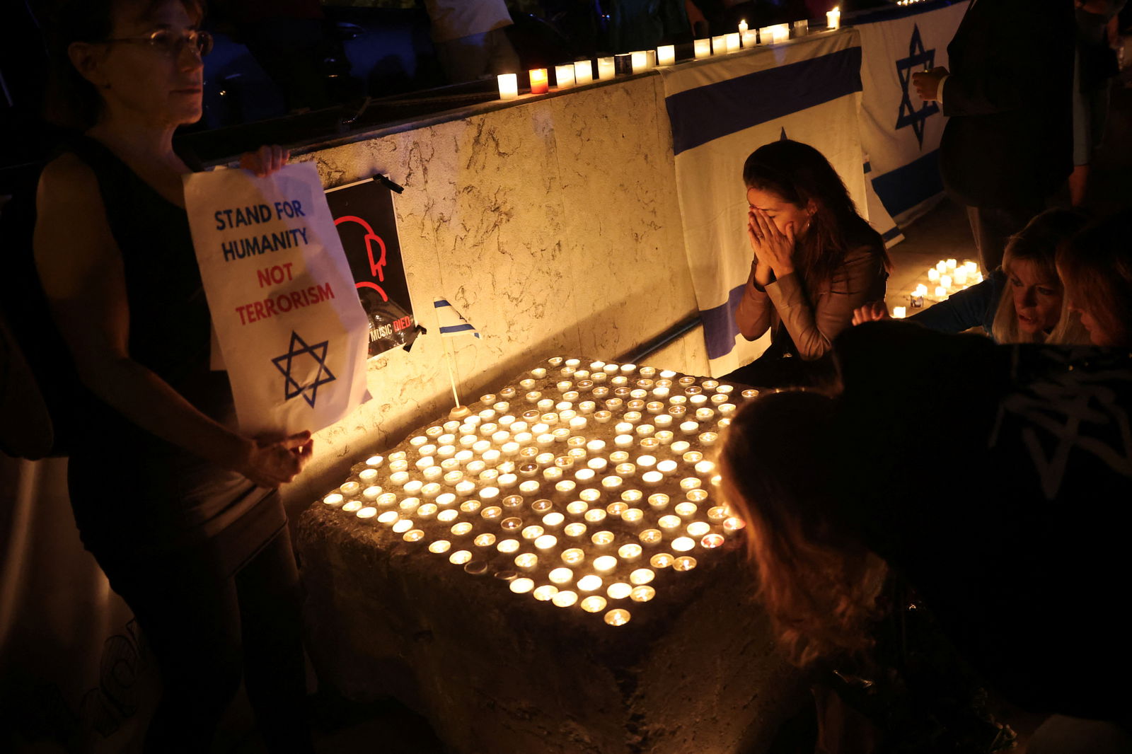 Pro-Israel demonstrators participate in a vigil for Israel amid the ongoing conflict between Israel and the Palestinian militant group Hamas, in Lisbon, Portugal October 10, 2023. 