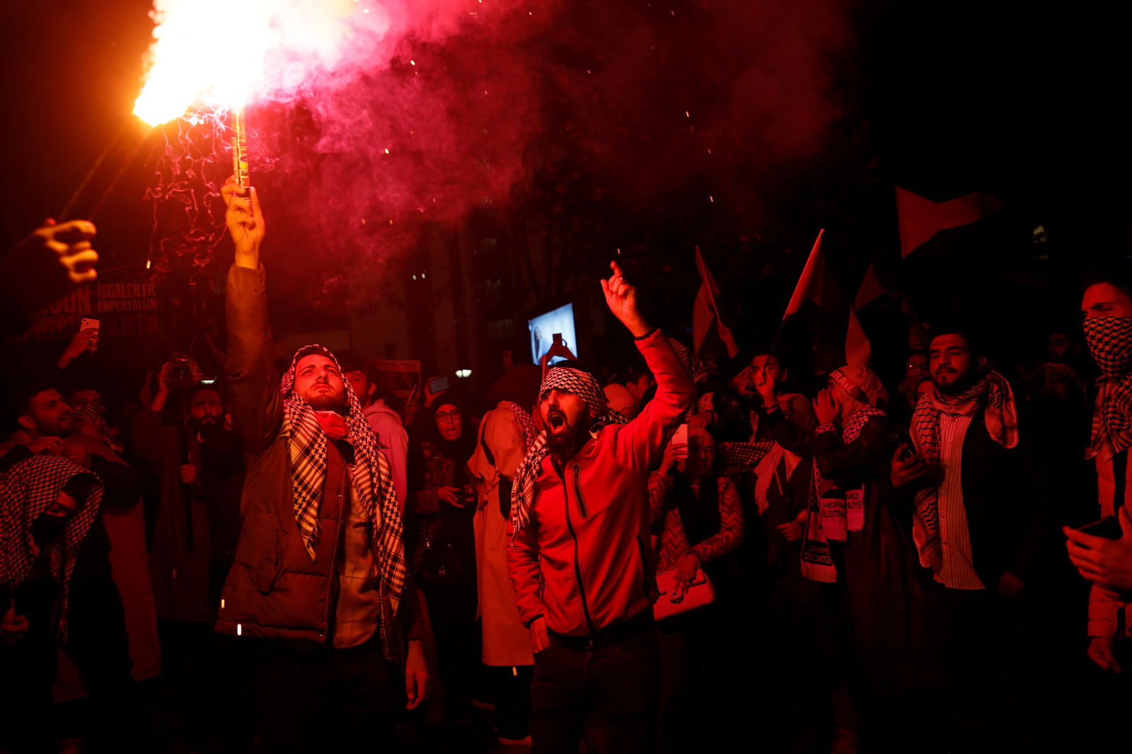 Pro-Palestinian demonstrators light flares during a protest near the Israeli Consulate as the conflict between Israel and Hamas continues, in Istanbul, Turkey October 18, 2023. 