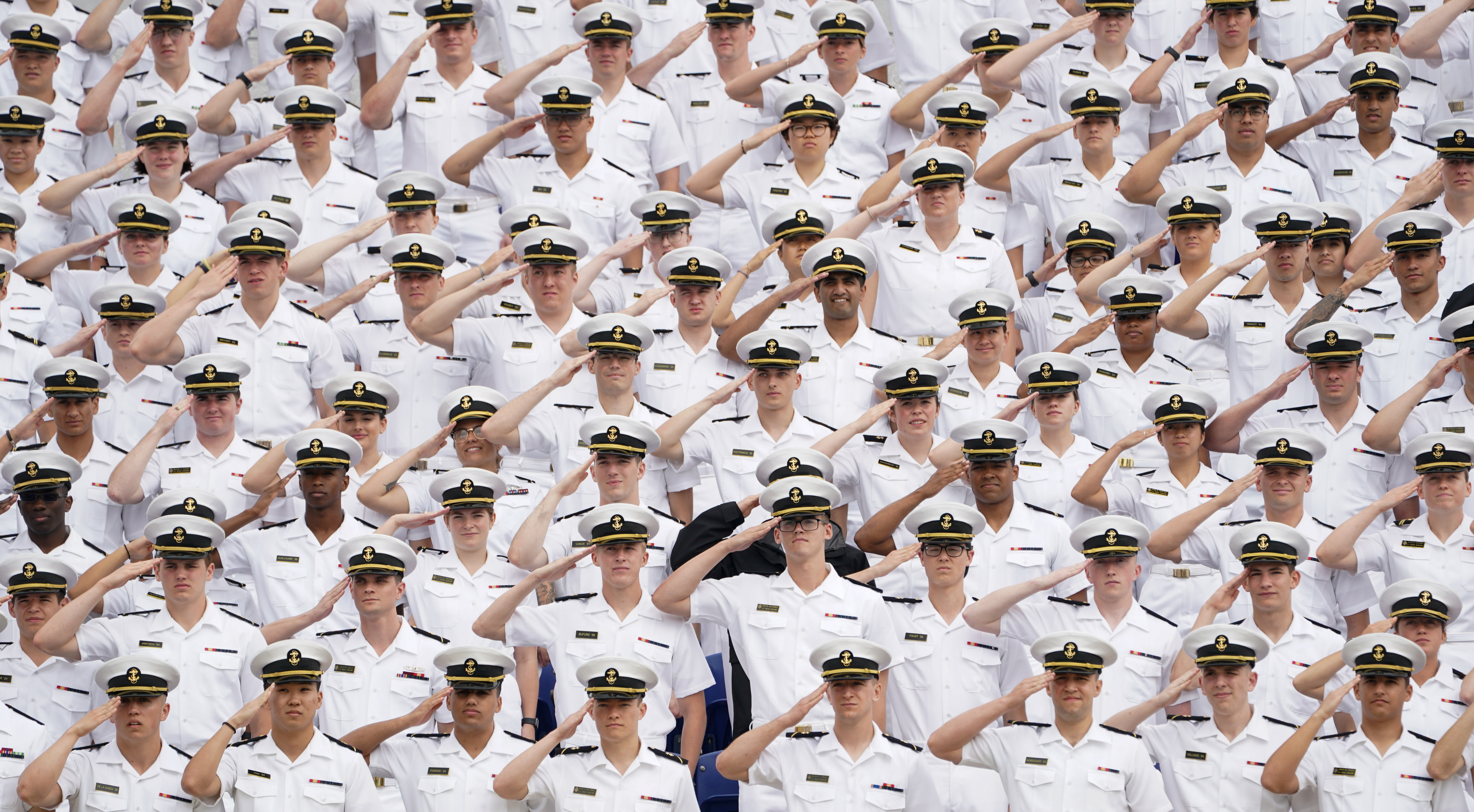 Underclass midshipmen salute during the national anthem at the U.S. Naval Academy graduation and commissioning ceremony in Annapolis, Maryland, U.S., May 27, 2022. 