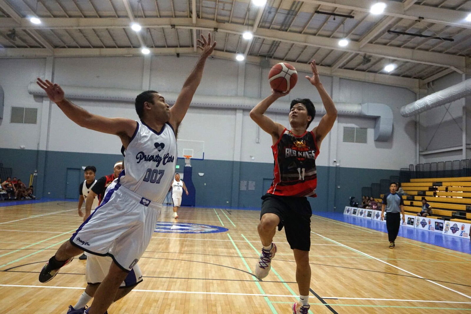 Marpac's Coby Santos attempts the floater over Priority Care's Marvin Rabauliman during a 2023 R&J Wine and Liquor Inter-Government/Business League game at the Ada gym.