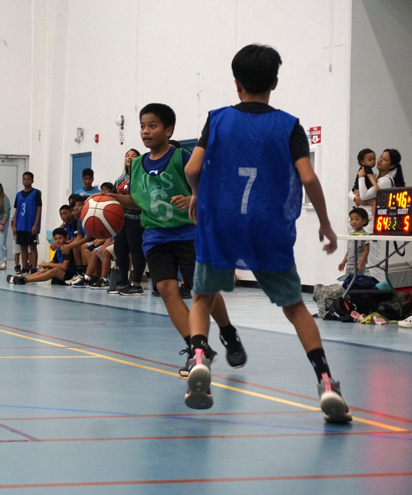 An MCS V player sets up the play as he dribbles against a defender during a boys middle school division game of the IT&E Interscholastic Basketball League at the MHS gym.