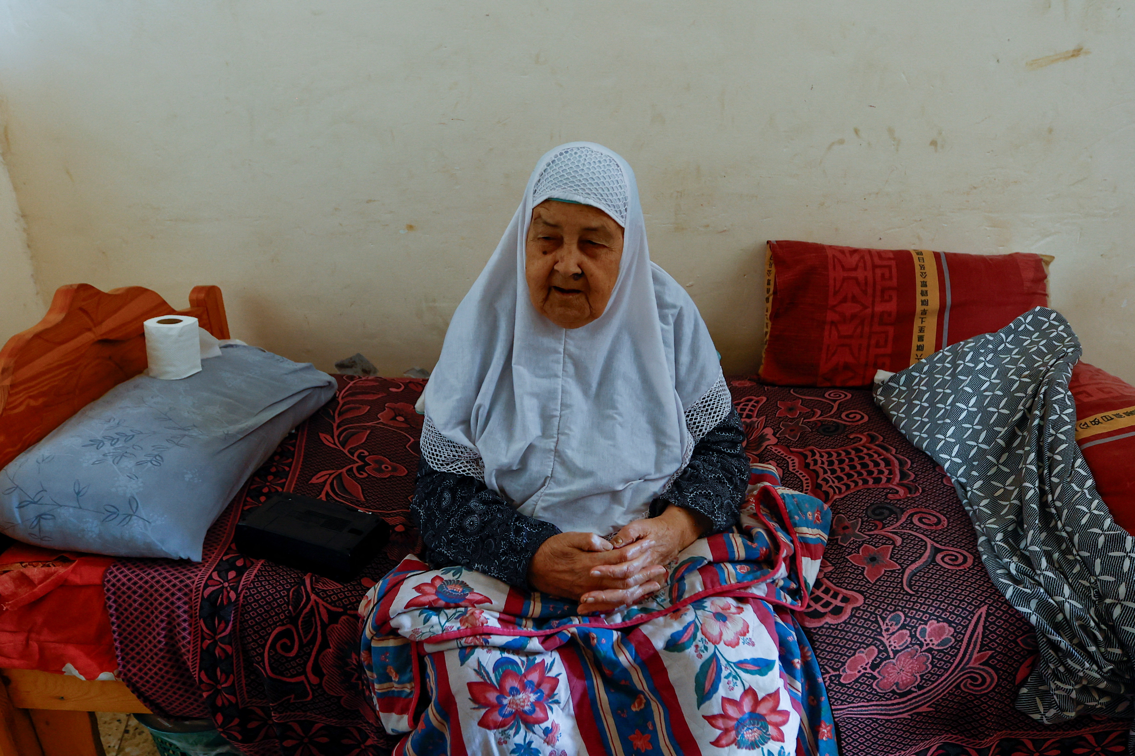 Palestinian woman Fawzeya Shaheen, 90, who lived through all Israeli-Palestinian wars dating back to 1948, sits at her home, amid the ongoing Israeli-Palestinian conflict, in Khan Younis in the southern Gaza Strip October 14, 2023. REUTERS/Ibraheem Abu Mustafa