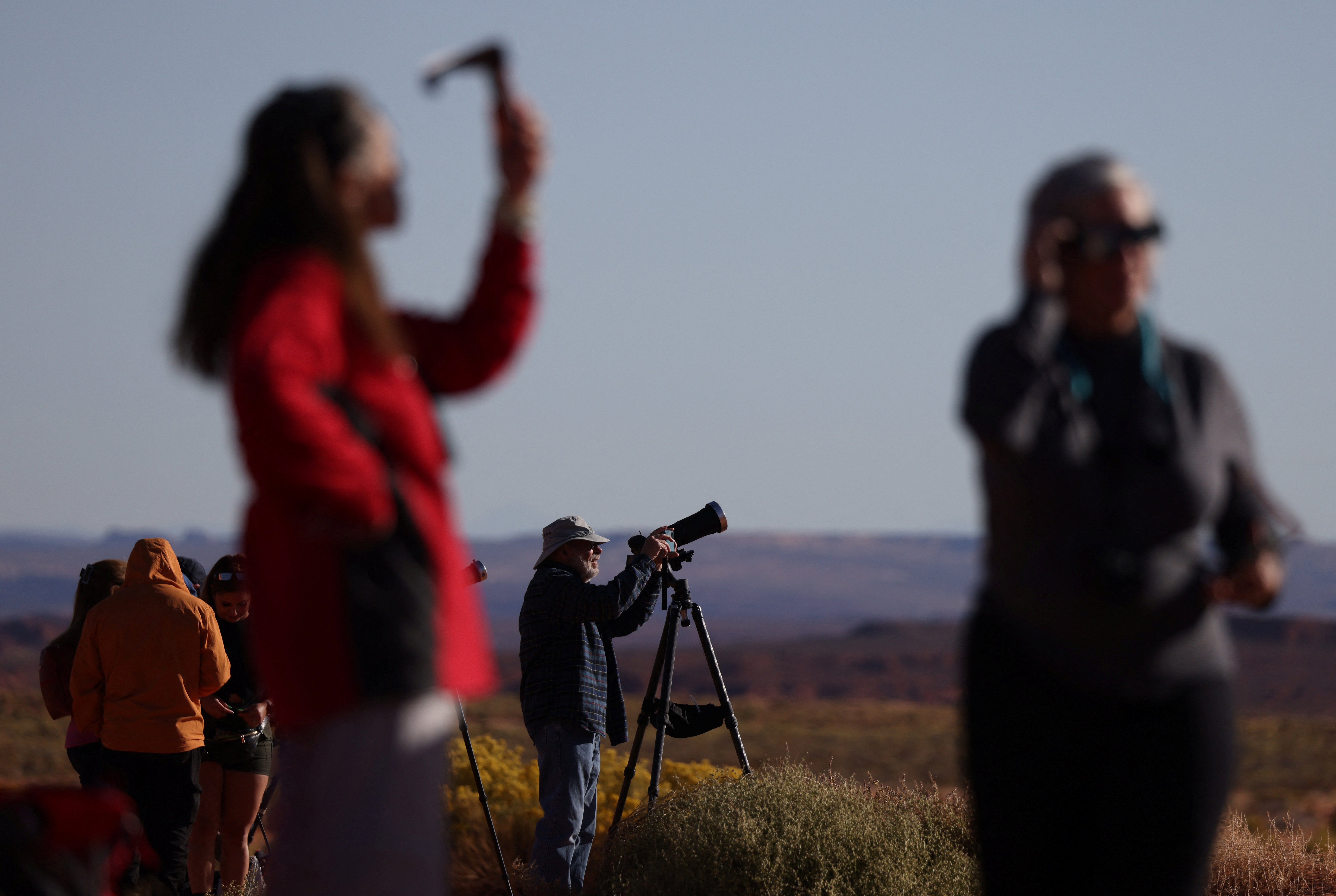 People gather to watch the annular solar eclipse at Monument Valley in the Navajo Nation, Arizona, U.S., October 14, 2023. REUTERS/Jim Urquhart