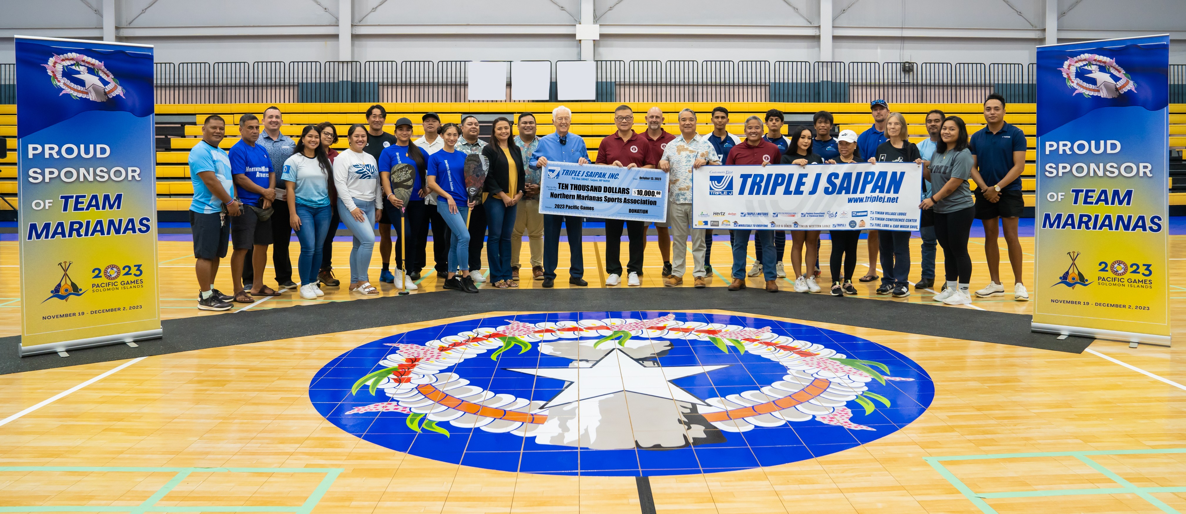 Triple J officials and Northern Marianas Sports Association President Jerry Tan pose for a photo with the NMI athletes that will compete in the 2023 Pacific Games from Nov. 19 to Dec. 2 in Honiara, the Solomon Islands.