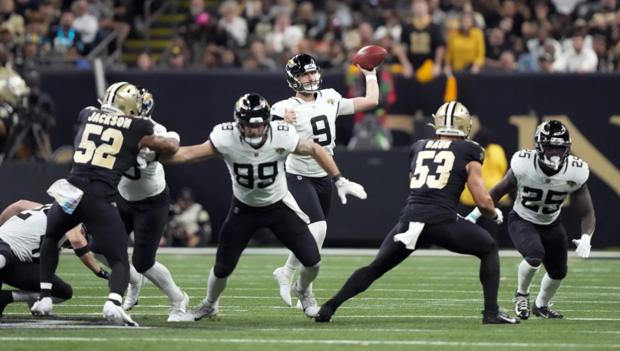 Jacksonville Jaguars punter Logan Cooke (9) throws a pass against the New Orleans Saints on a fake punt play in the first half of an NFL game in New Orleans, Thursday, Oct. 19, 2023.