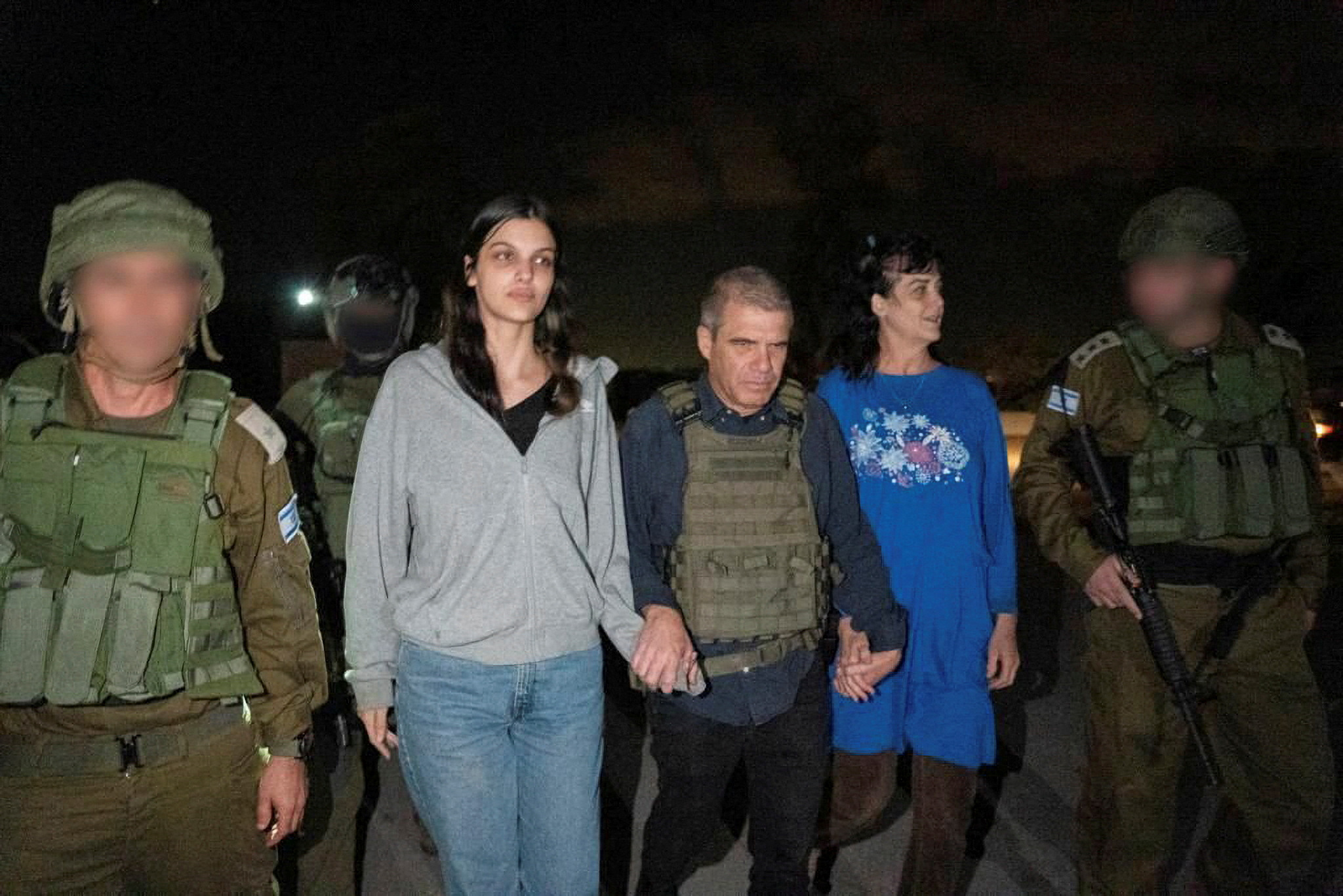 Judith Tai Raanan and her daughter Natalie Shoshana Raanan, U.S. citizens who were taken as hostages by Palestinian Hamas militants, walk while holding hands with Brig.-Gen. (Ret.) Gal Hirsch, Israel's Coordinator for the Captives and Missing, after they were released by the militants, in response to Qatari mediation efforts, in this handout picture obtained by Reuters on October 20, 2023. 