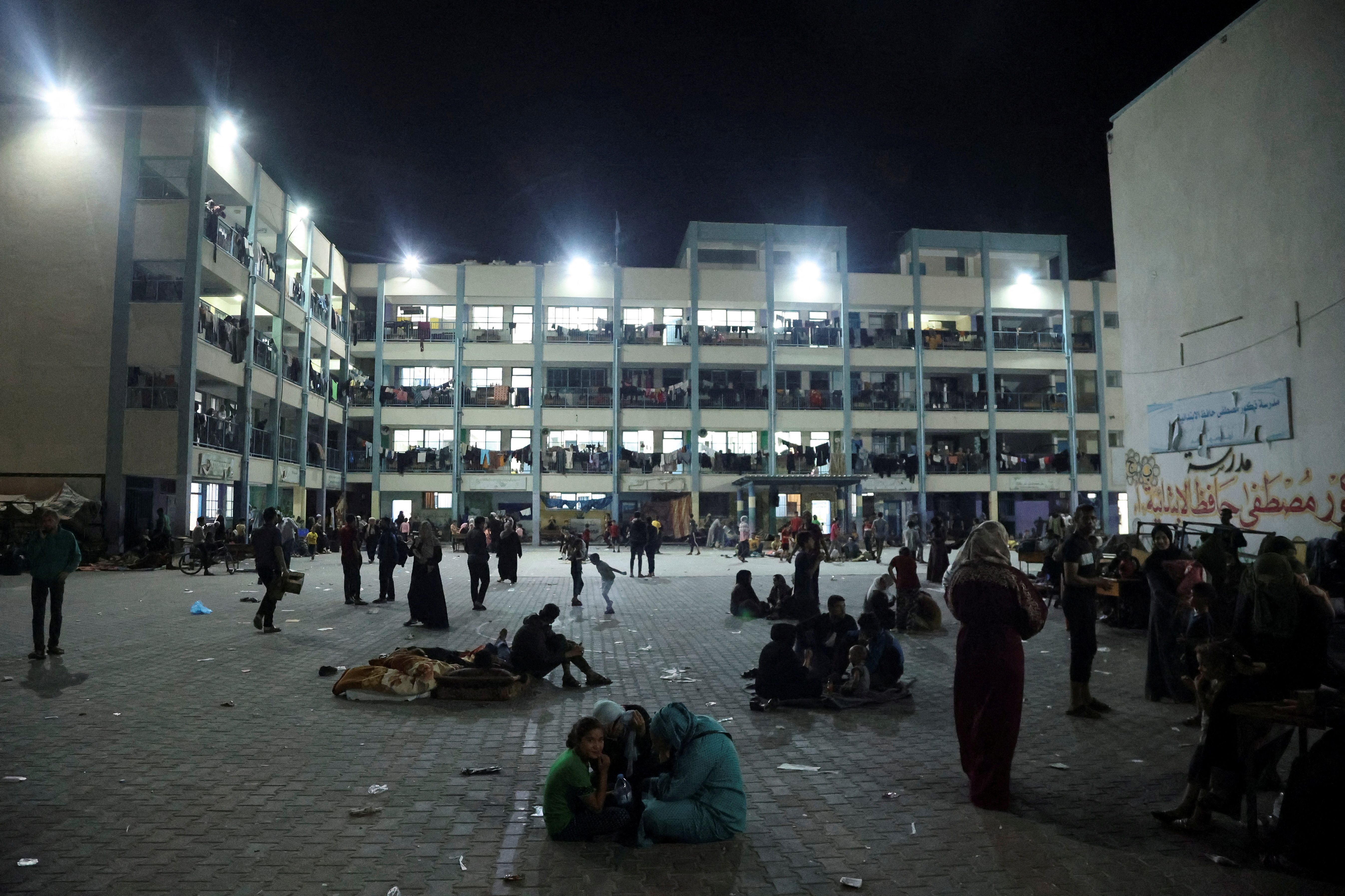Palestinians, who fled their houses amid Israeli strikes, shelter at a United Nations-run school, after Israel's call for more than 1 million civilians in northern Gaza to move south, in Khan Younis in the southern Gaza Strip October 14, 2023. REUTERS/Ahmed Zakot