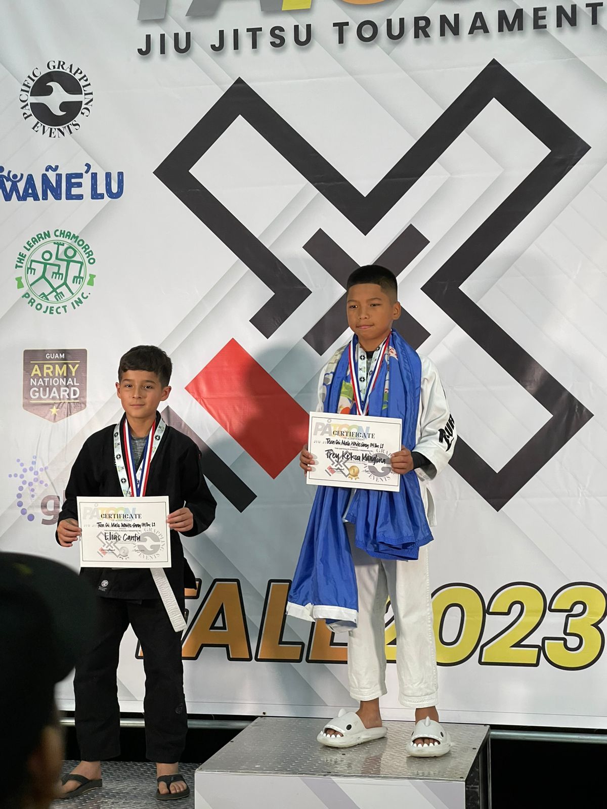 Trench Tech Purebred Saipan's Trey Manglona and Guam's Elias Cantu hold their awards after the championship match of the Patgon Jiujitsu Tournament Fall 2023 at the University of Guam Fieldhouse on Saturday.