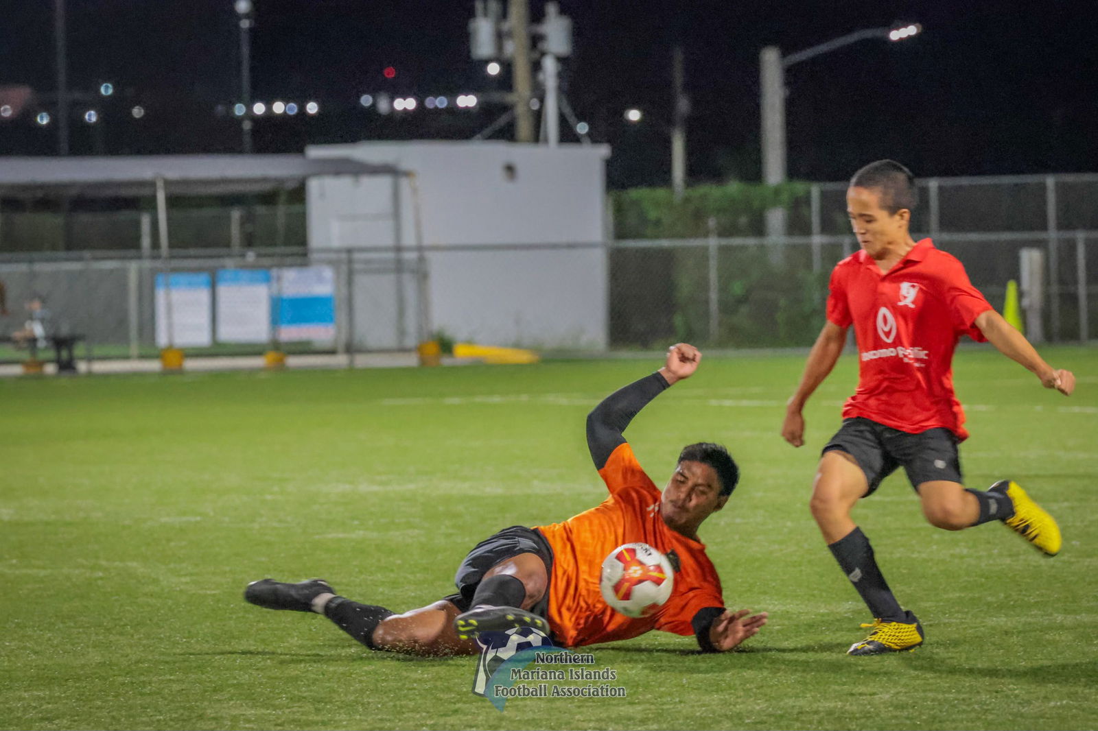 Kanoa's Andruw Omelau slides to intercept the possession during a game against Paire in the Marianas Soccer League 1 at the NMI Soccer Training Center in Koblerville.