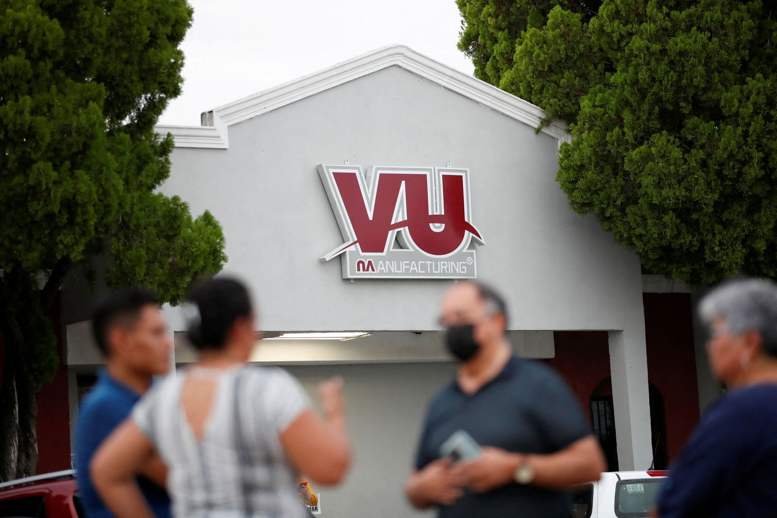 Members of the Liga Obrera Sindical Mexicana (Mexican Workers Union League) talk outside the VU Manufacturing auto parts plant in Piedras Negras, Mexico, August 31, 2022. 
