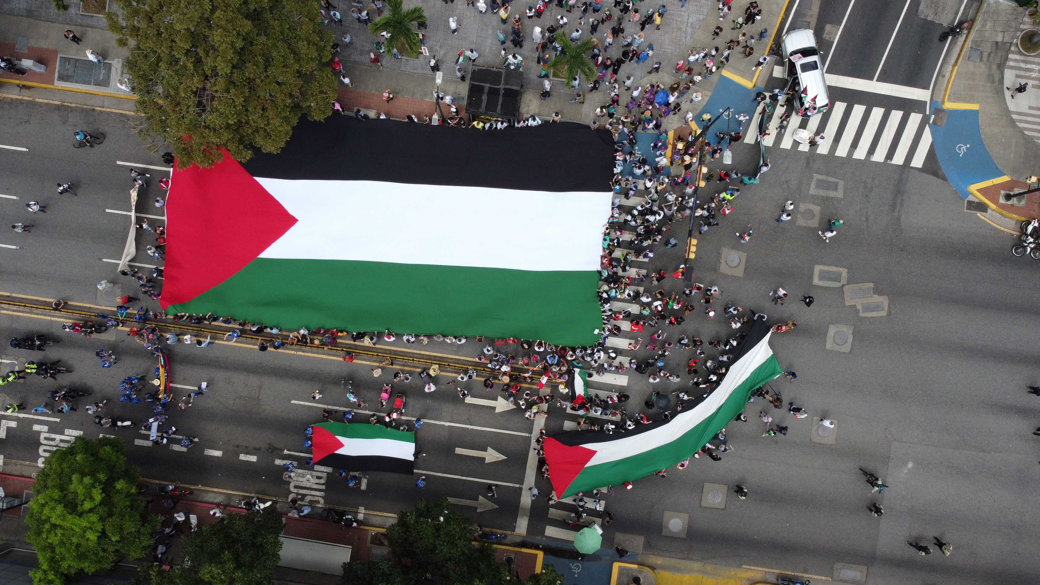 People hold a Palestinian flag during a demonstration in support of Palestinians, outside a United Nations headquarters in Caracas, Venezuela October 21, 2023. 