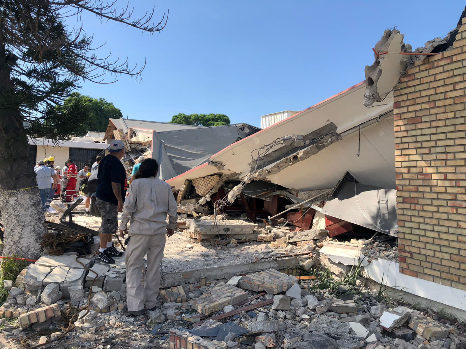Members of a rescue team and people work at a site where a church roof collapsed during Sunday mass in Ciudad Madero, in Tamaulipas state, Mexico in this handout picture distributed to Reuters on October 1, 2023. 