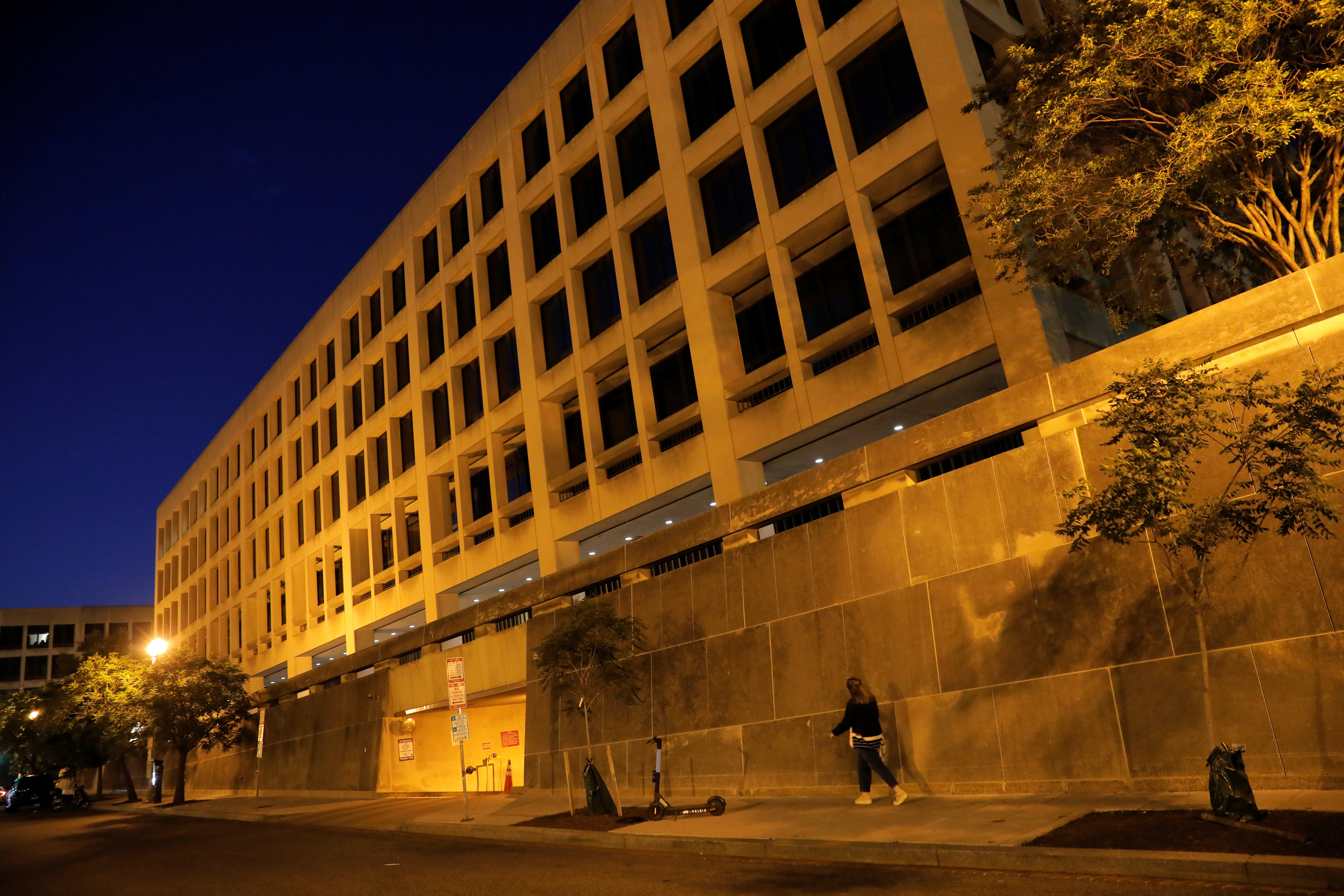 A person walks by the Department of Labor headquarters in Washington, D.C., U.S., May 13, 2021. 