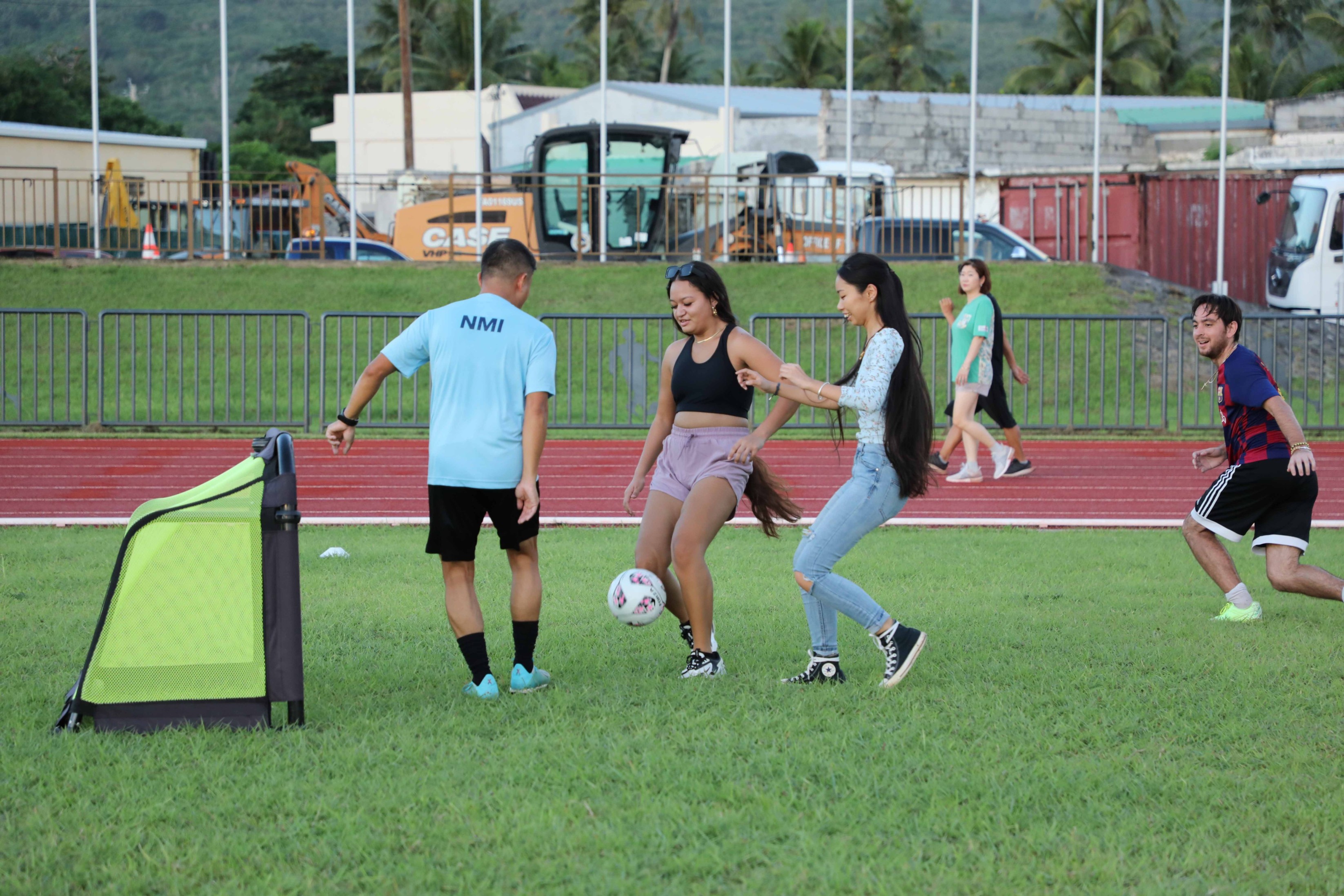 Jersh Angeles, Tamisha Sablan, Rain Ni play soccer on Sept. 20, 2023, the 4th annual International Day of University Sports.