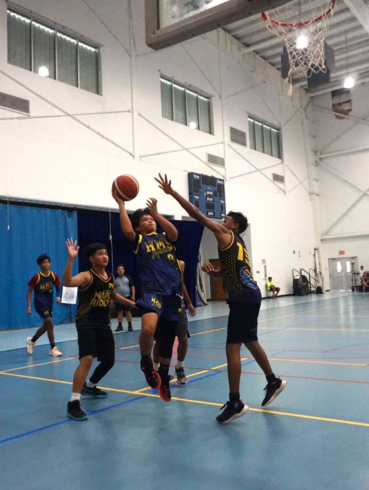 HMS' Jequinn Lizama takes the contested shot during the boys middle school division championship of the IT&E Interscholastic Basketball League SY23-24 at the Marianas High School gym on Saturday.