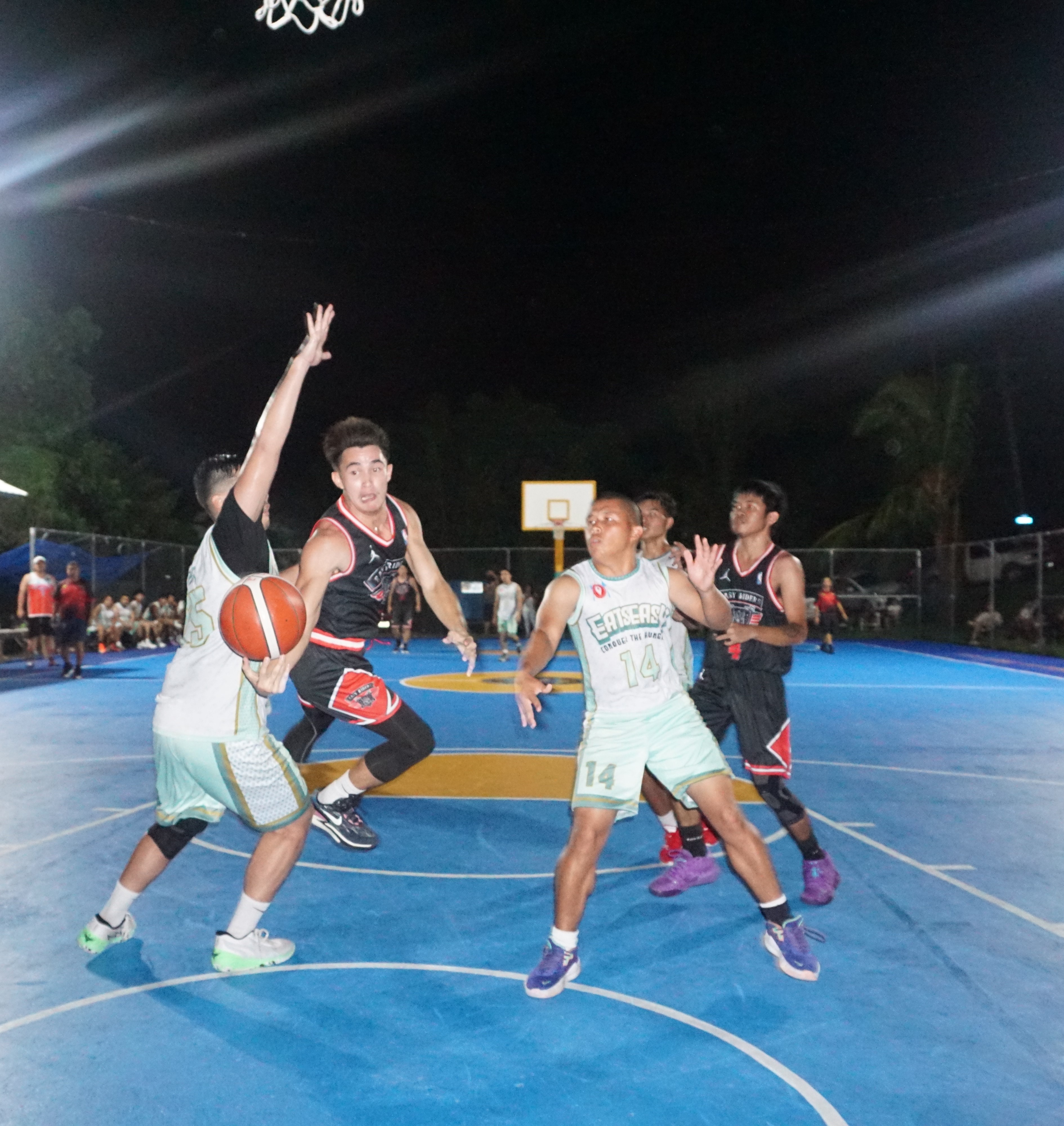 Easy Riders' Cris Diwa dishes out a pass in midair during a semifinal game of the 2023 Saipan Magalahi Eagles Club Invitational Basketball League at the Gualo Rai basketball court on Saturday.