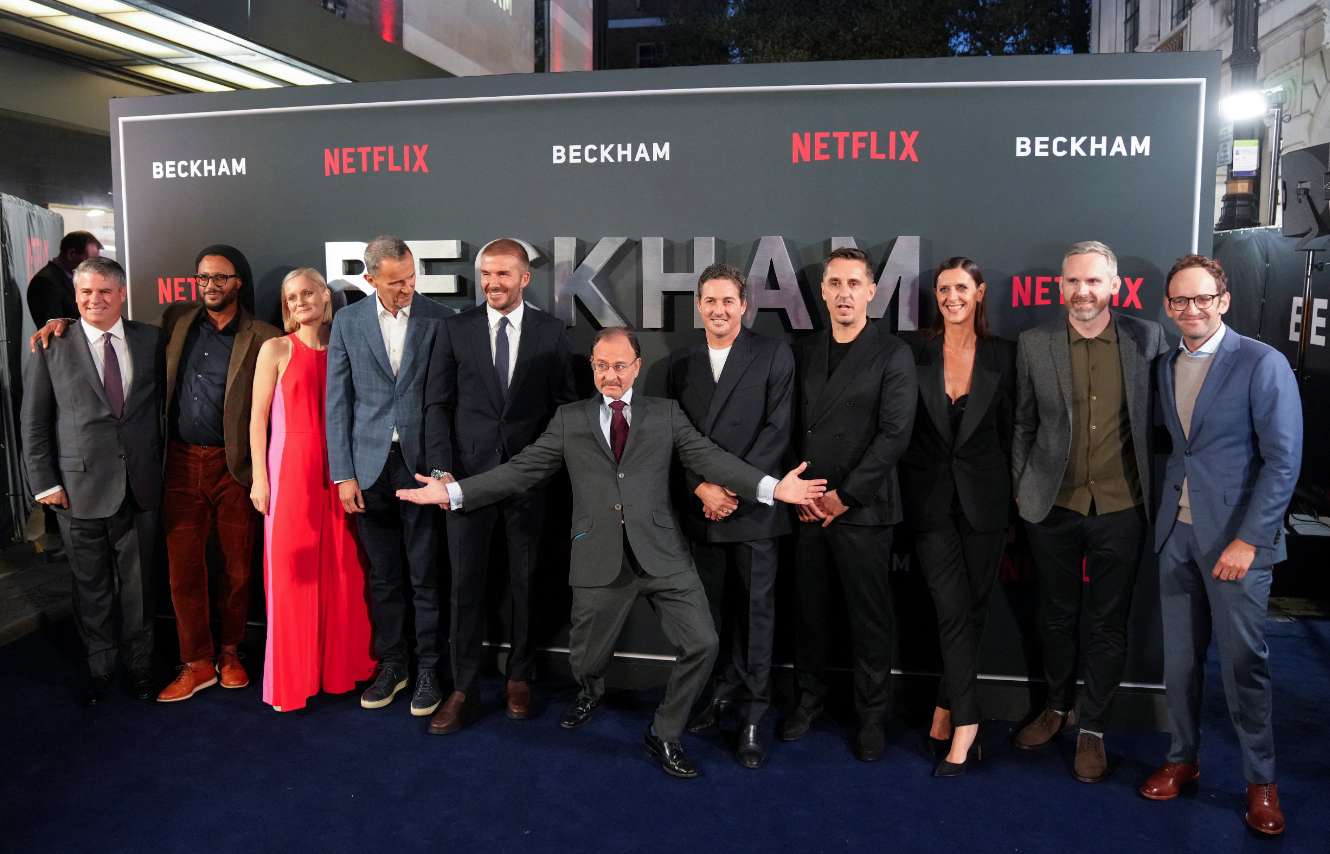 Director Fisher Stevens and former football player David Beckham pose for a group photo at the premiere of a Netflix documentary, “Beckham,” in London, Britain, Oct. 3, 2023.