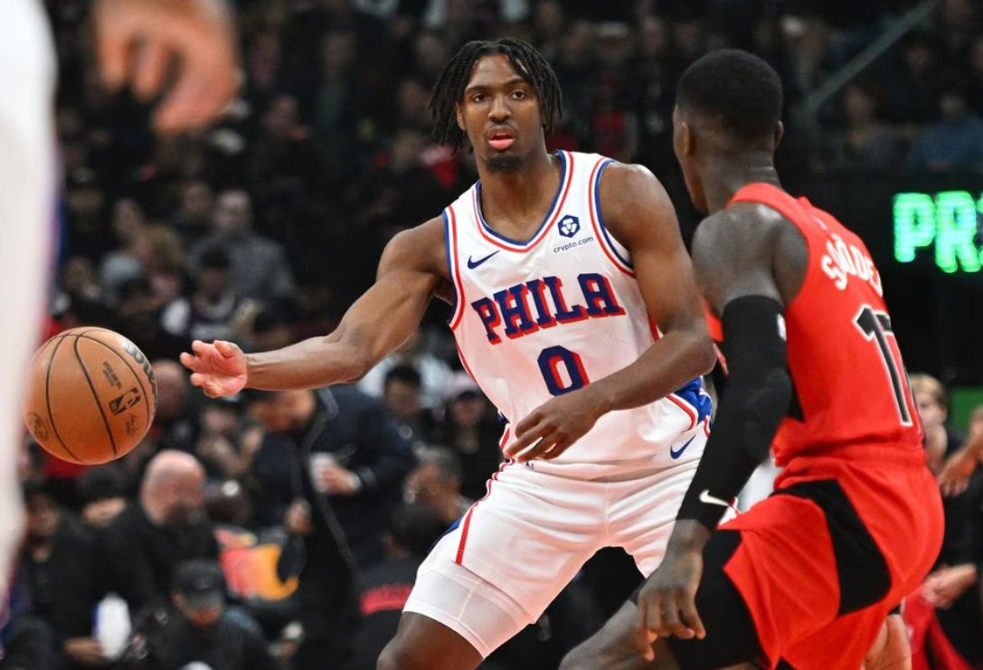 Philadelphia 76ers guard Tyrese Maxey (0) passes the ball away from Toronto Raptors guard Dennis Schroder (17) in the first half at Scotiabank Arena in Toronto, Ontario, Canada, Oct. 28, 2023.