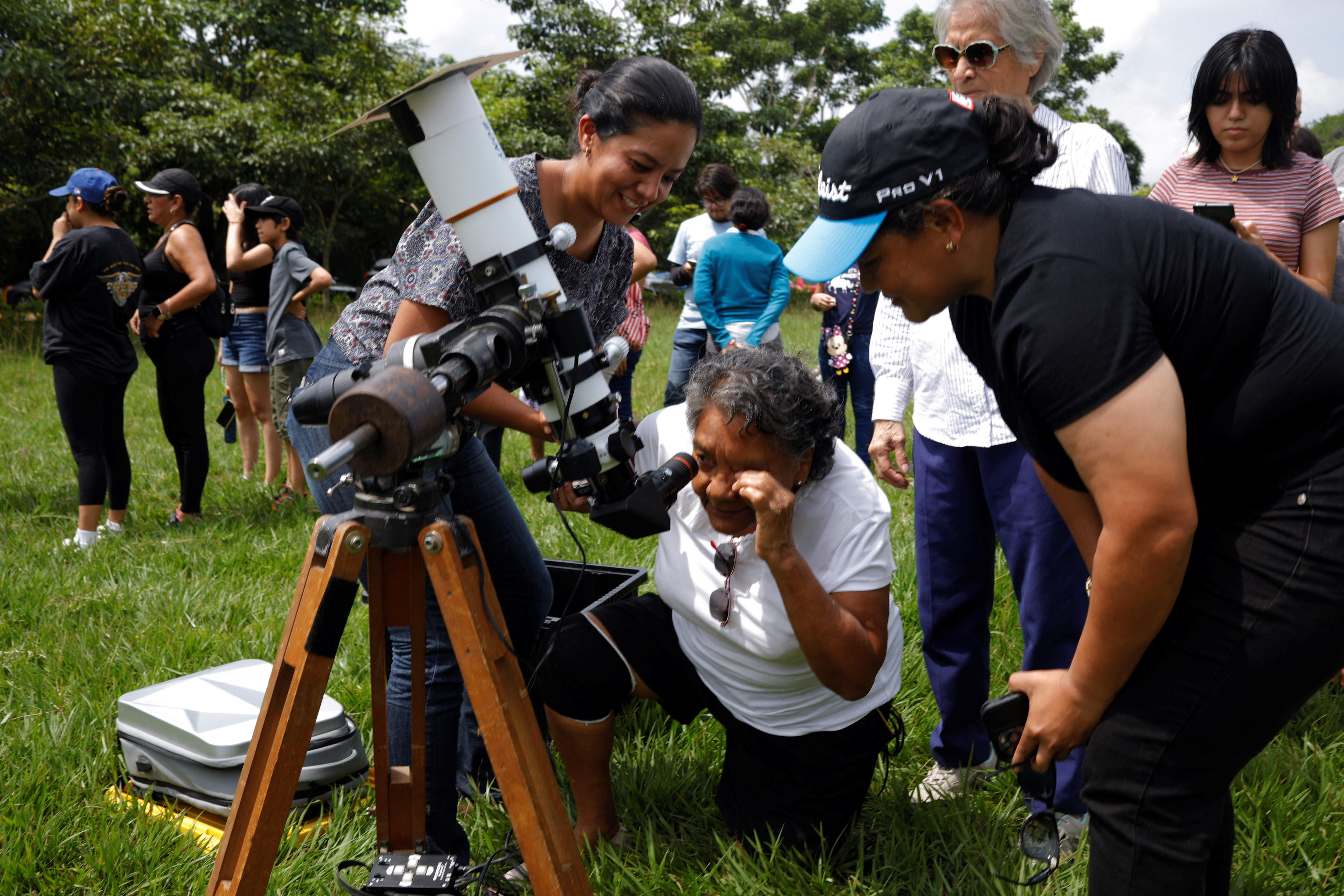 People gather to watch the solar eclipse at the Bicentenario Park in Antiguo Cuscatlan, El Salvador October 14, 2023. REUTERS/Jose Cabezas