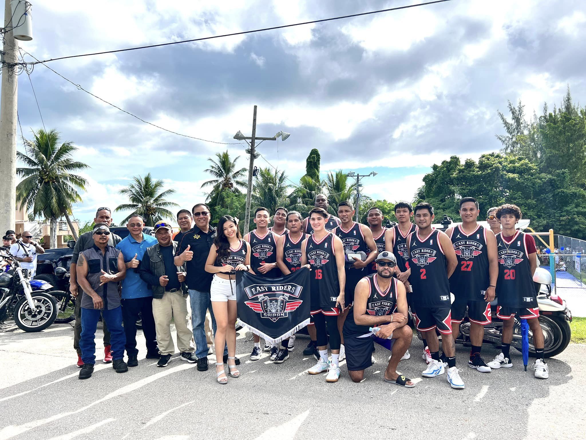 The Easy Riders pose for a photo at the Gualo Rai basketball court.