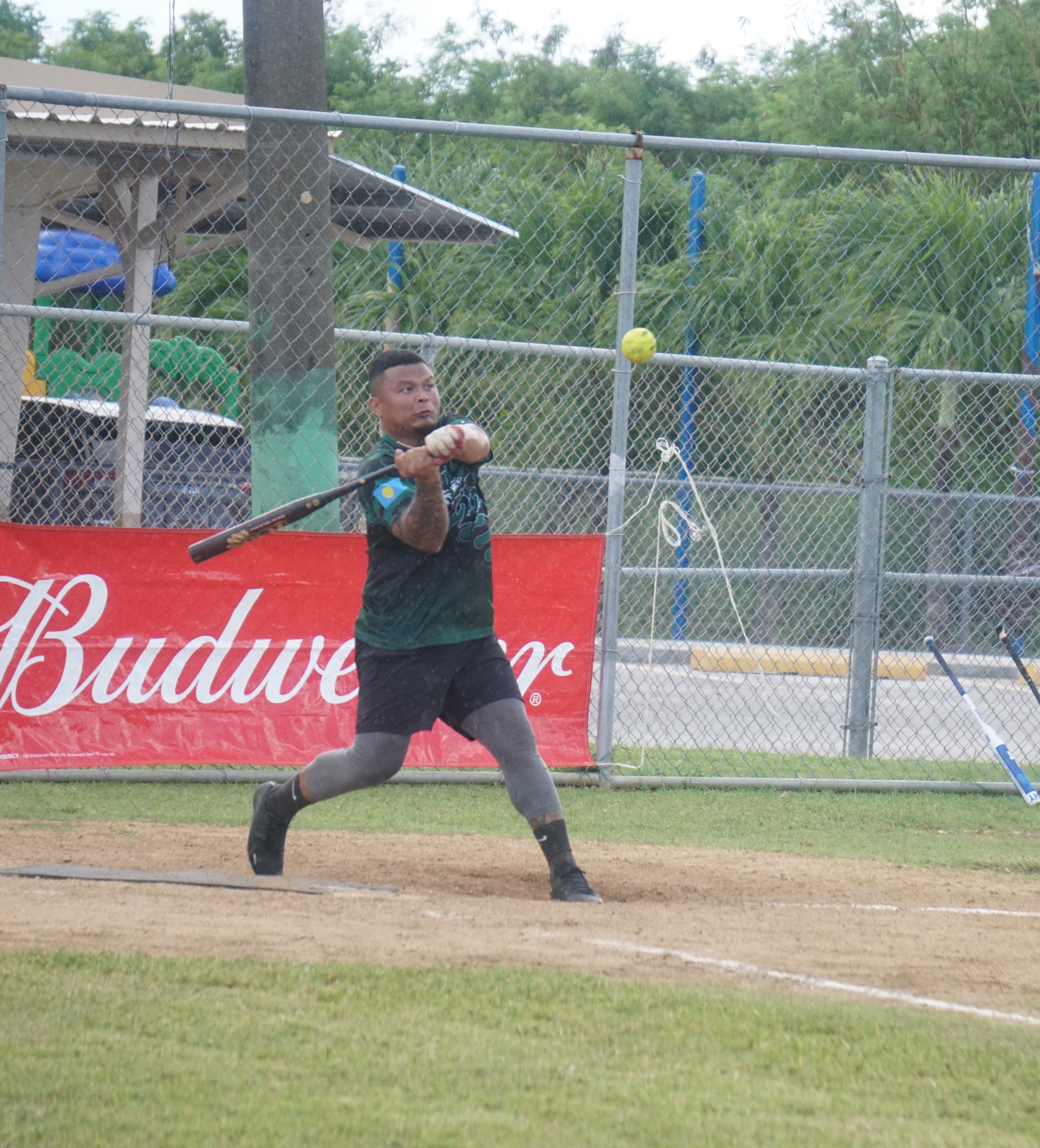 Aimeliik Bat Boyz's Irvin Saralu (not Jimmy Demapan as earlier reported) connects a double during the championship game of the 2023 Budweiser Belau Amateur Softball Association Open League at the Dandan baseball field on Sunday.