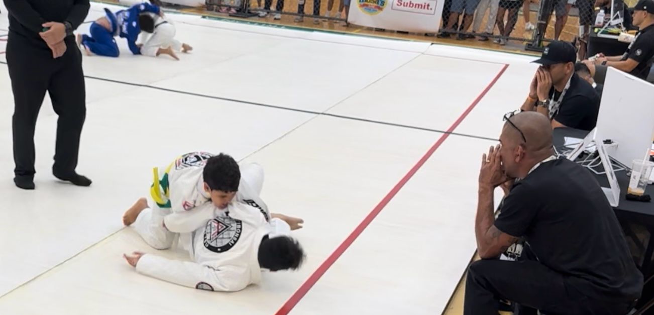 Saipan’s Mateo Almada pins Guam's Michael Paul to the canvass in the semifinal round as Trench Tech Purebred Saipan's Cuki Alvarez watches.