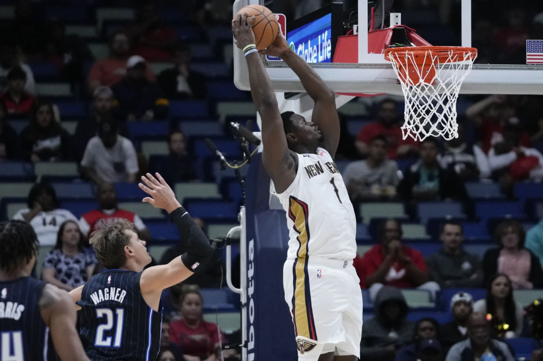 New Orleans Pelicans forward Zion Williamson goes to the basket to slam dunk over Orlando Magic center Moritz Wagner in the first half of an NBA preseason game in New Orleans, Tuesday, Oct. 10, 2023.