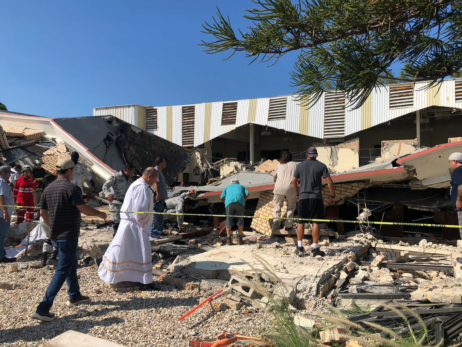 Members of security forces, people and a priest work at a site where a church roof collapsed during Sunday mass in Ciudad Madero, in Tamaulipas state, Mexico in this handout picture distributed to Reuters on October 1, 2023. 