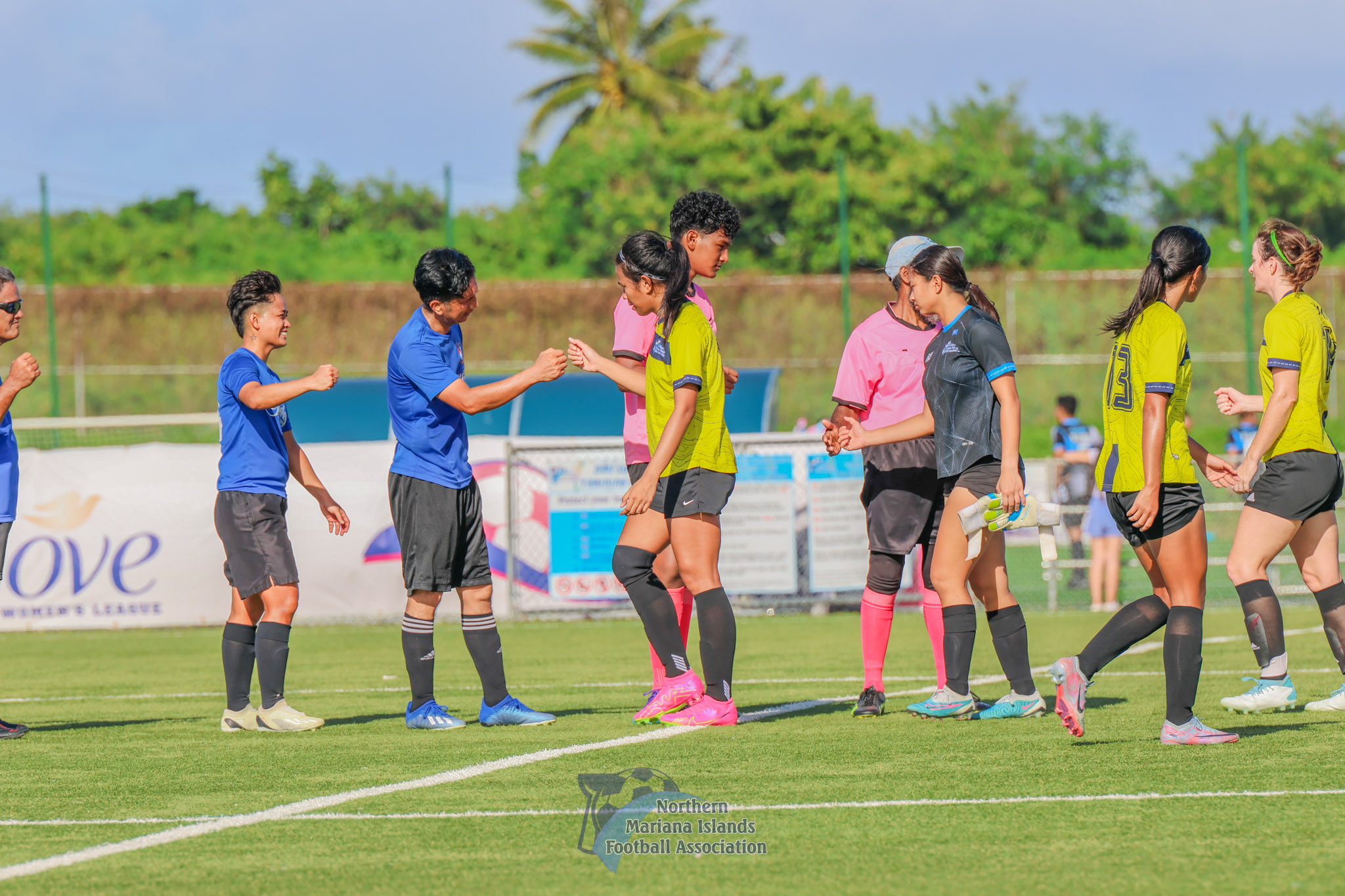 Shirley's Football Club and WNT Development Team players bump fists after their game in the Marianas Soccer League 2 at the NMI Soccer Training Center on Friday.