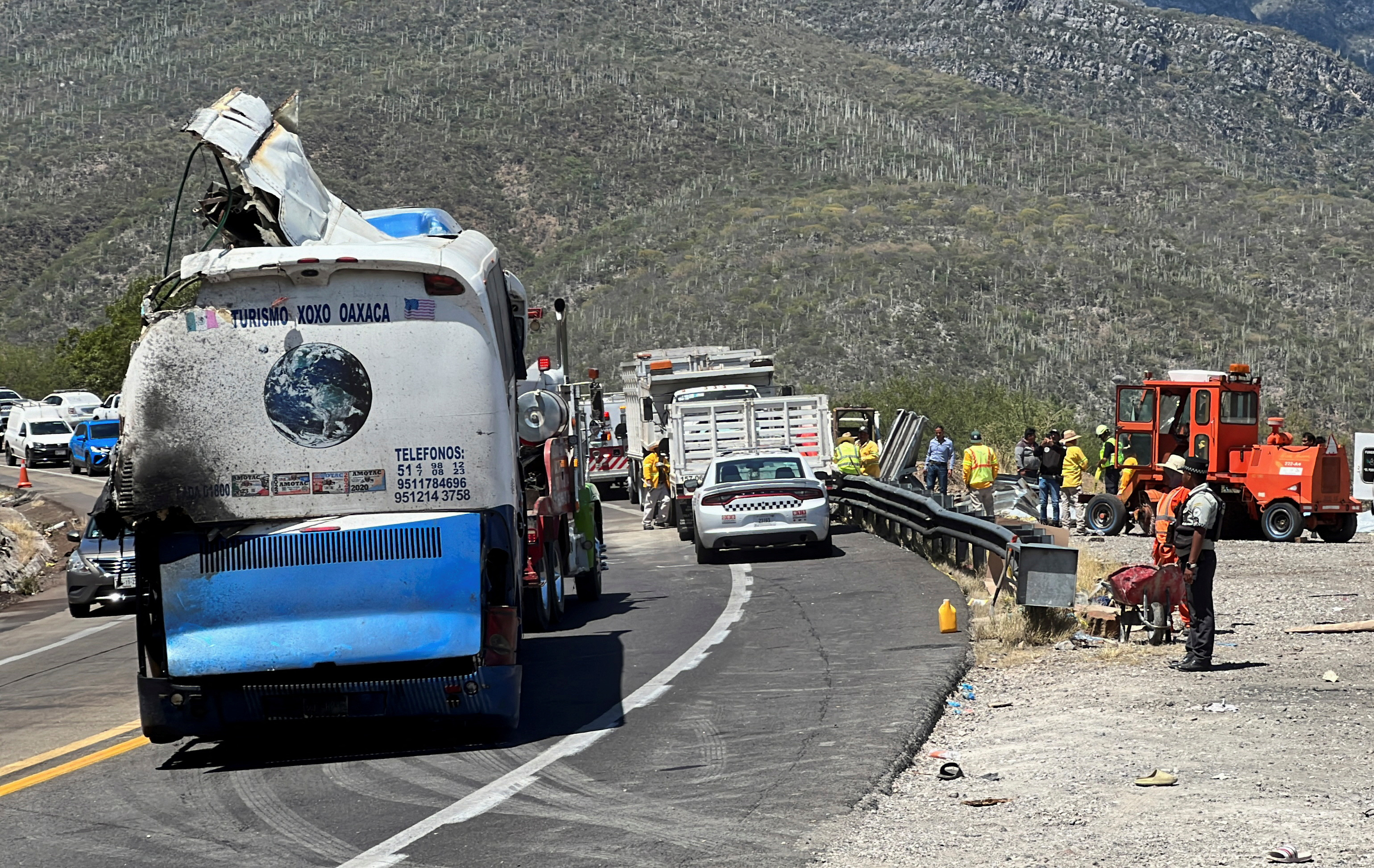 A tow truck moves a bus, on the scene of a road accident, after a bus carrying dozens of mostly Venezuelan migrants crashed, which left some of the passengers dead and wounded others, on the highway near Tepelmeme Villa de Morelos, in the southern state of Oaxaca, Mexico October 6, 2023. 