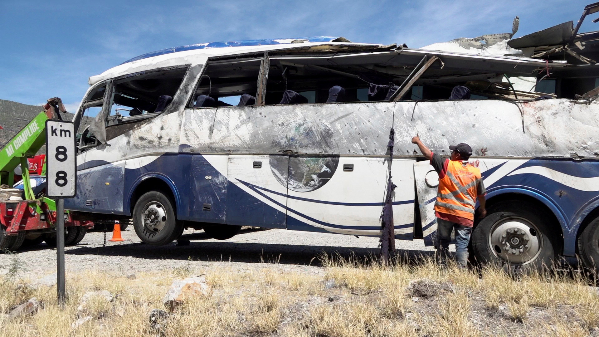 A tow truck moves a bus, on the scene of a road accident, after a bus carrying dozens of mostly Venezuelan migrants crashed, which left some of the passengers dead and wounded others, on the highway near Tepelmeme Villa de Morelos, in the southern state of Oaxaca, Mexico October 6, 2023. 