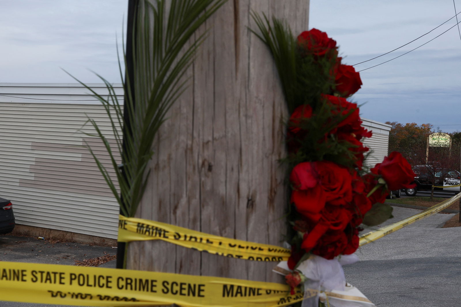 A view of police tape and flowers at a makeshift memorial near the Schemengees Bar & Grille Restaurant, one of the locations of the deadly mass shootings, in Lewiston, Maine, U.S., October 29, 2023. 