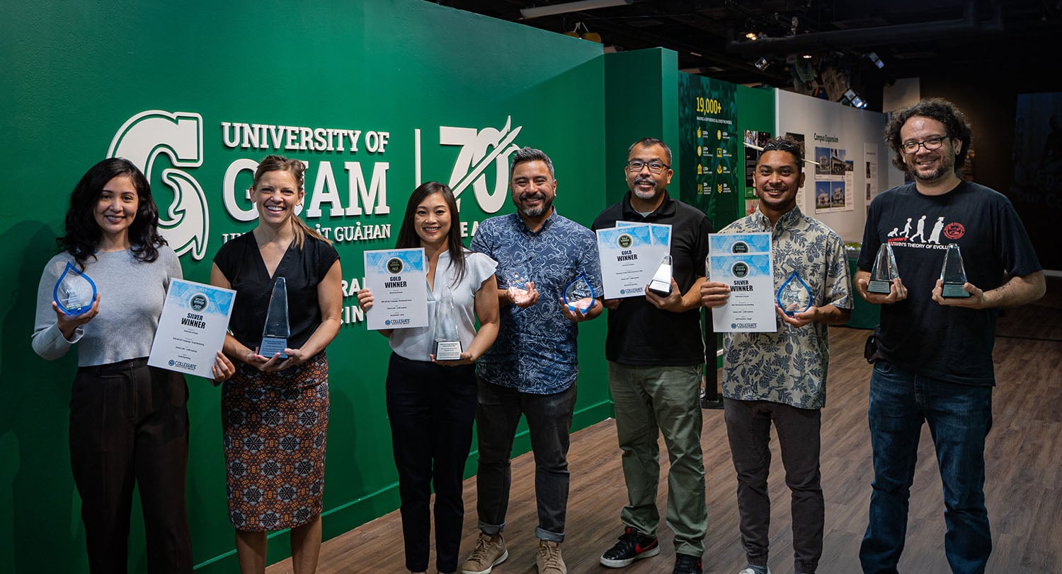 The UOG Marketing & Communications team and UOG Web Team hold the awards they received for projects completed in 2021 at the University of Guam 70th Anniversary Exhibit in August 2022 at the Guam Museum. From left, team members at the time included Laura Pangelinan, Jackie Hanson, Bernie Capindo, Chief Marketing & Communications Officer Jonas Macapinlac, Gene Herrera, Eurich Patacsil, and Matt Raymundo.