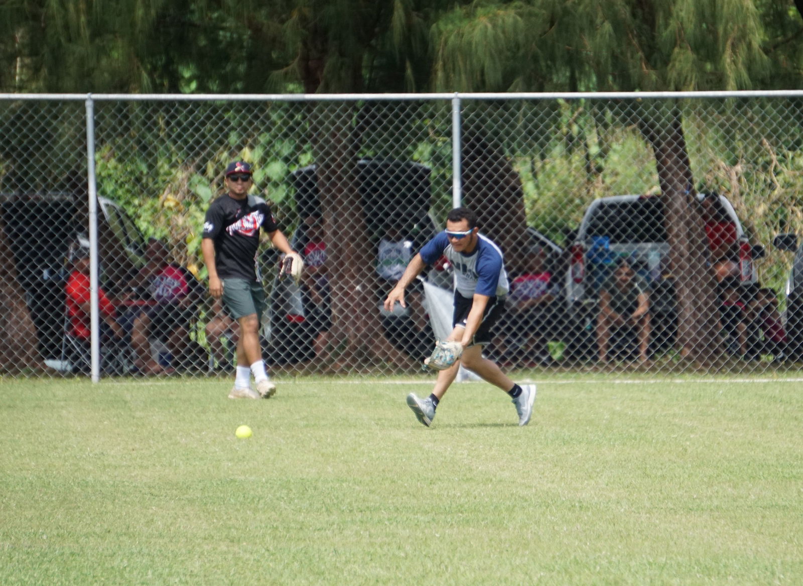 Just4Fun's Shane Yamada reaches to secure the grounder during a playoff game of the 2023 Budweiser Belau Amateur Softball Association Open League at the Dandan baseball field on Sunday.