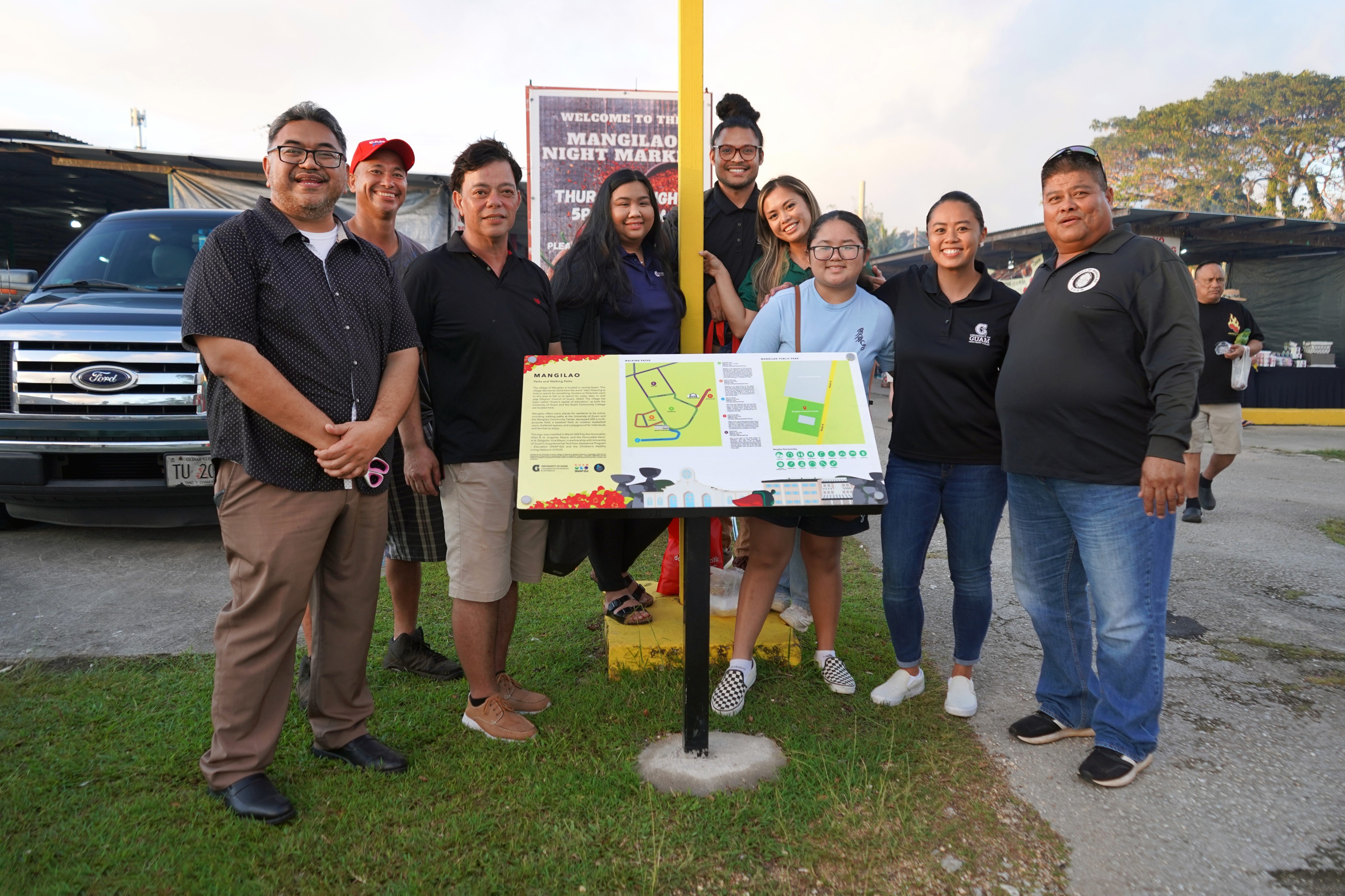 Mangilao Mayor Allan Ungacta, right, and Vice Mayor Kevin Delgado, left, with Mangilao residents and the Community Nutrition Education Program team from the University of Guam at the unveiling of a walking paths sign across from the Mangilao Community Center and Mangilao Mayor’s Office.