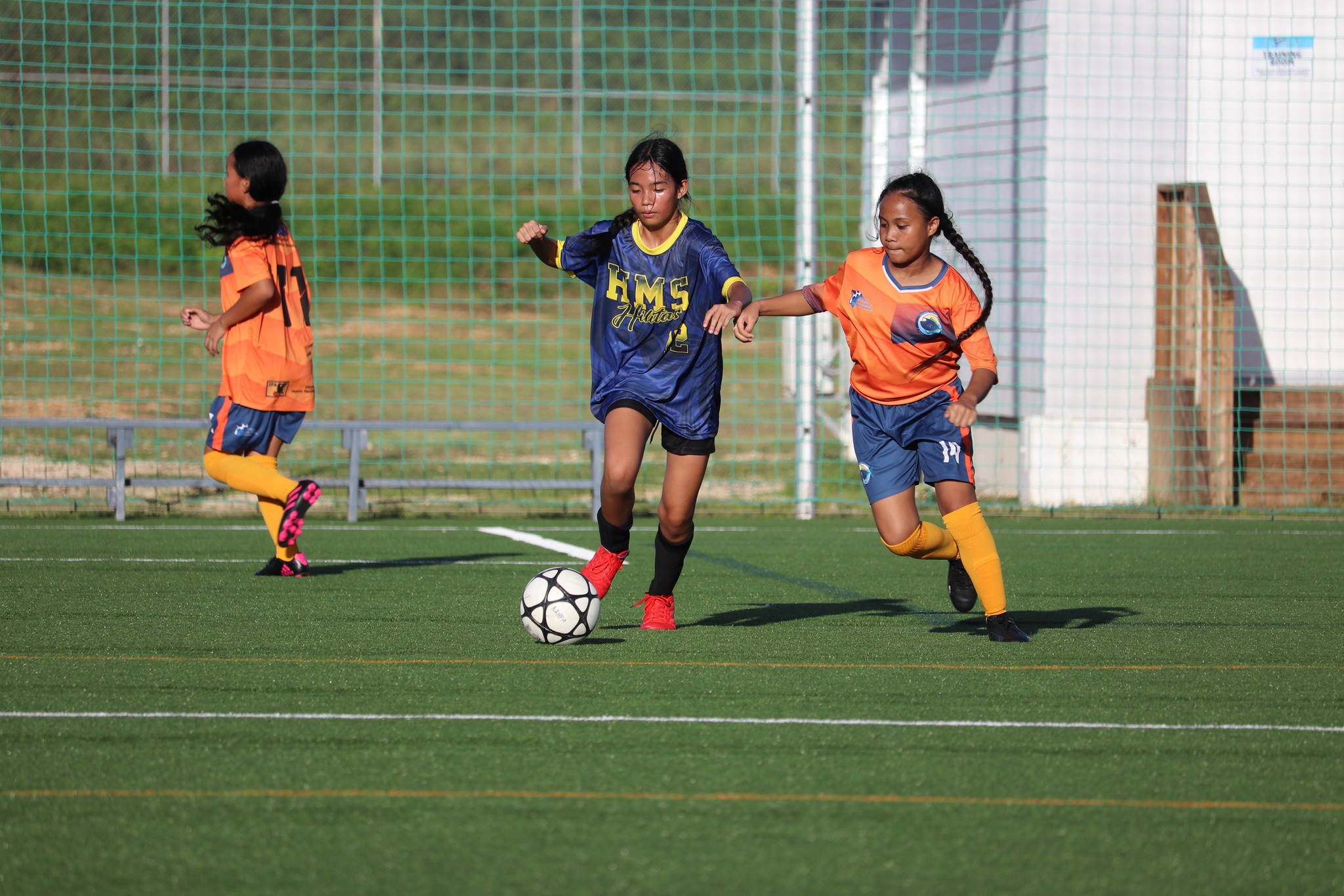 Hopwood’s Elyza Brillo dribbles past a Tanapag defender during a girls middle school division game of the NMIFA-PSS Interscholastic Soccer League at the NMI Soccer Training Center in Koblerville on Friday.