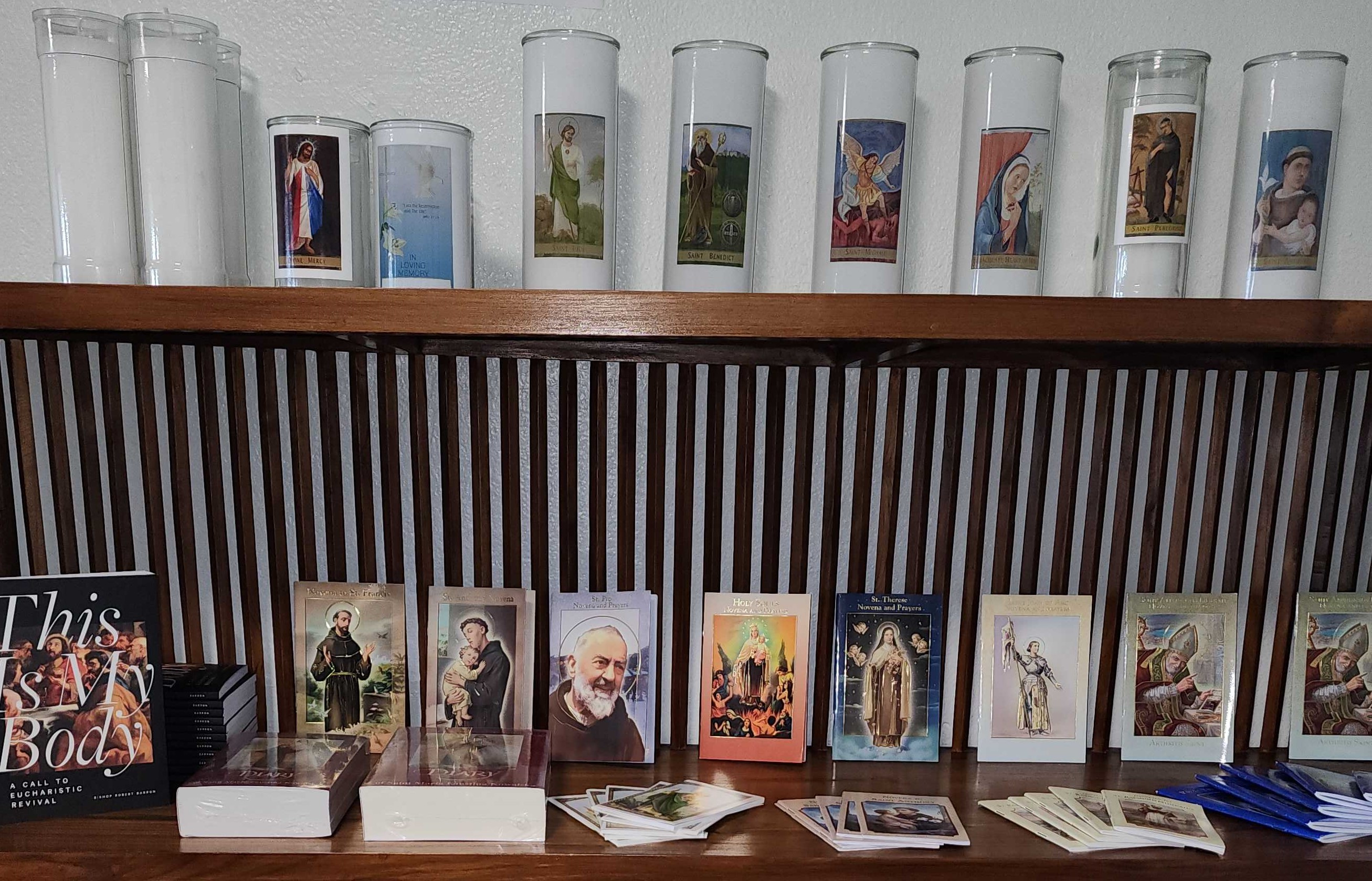 Devotional candles with images of patron saints.