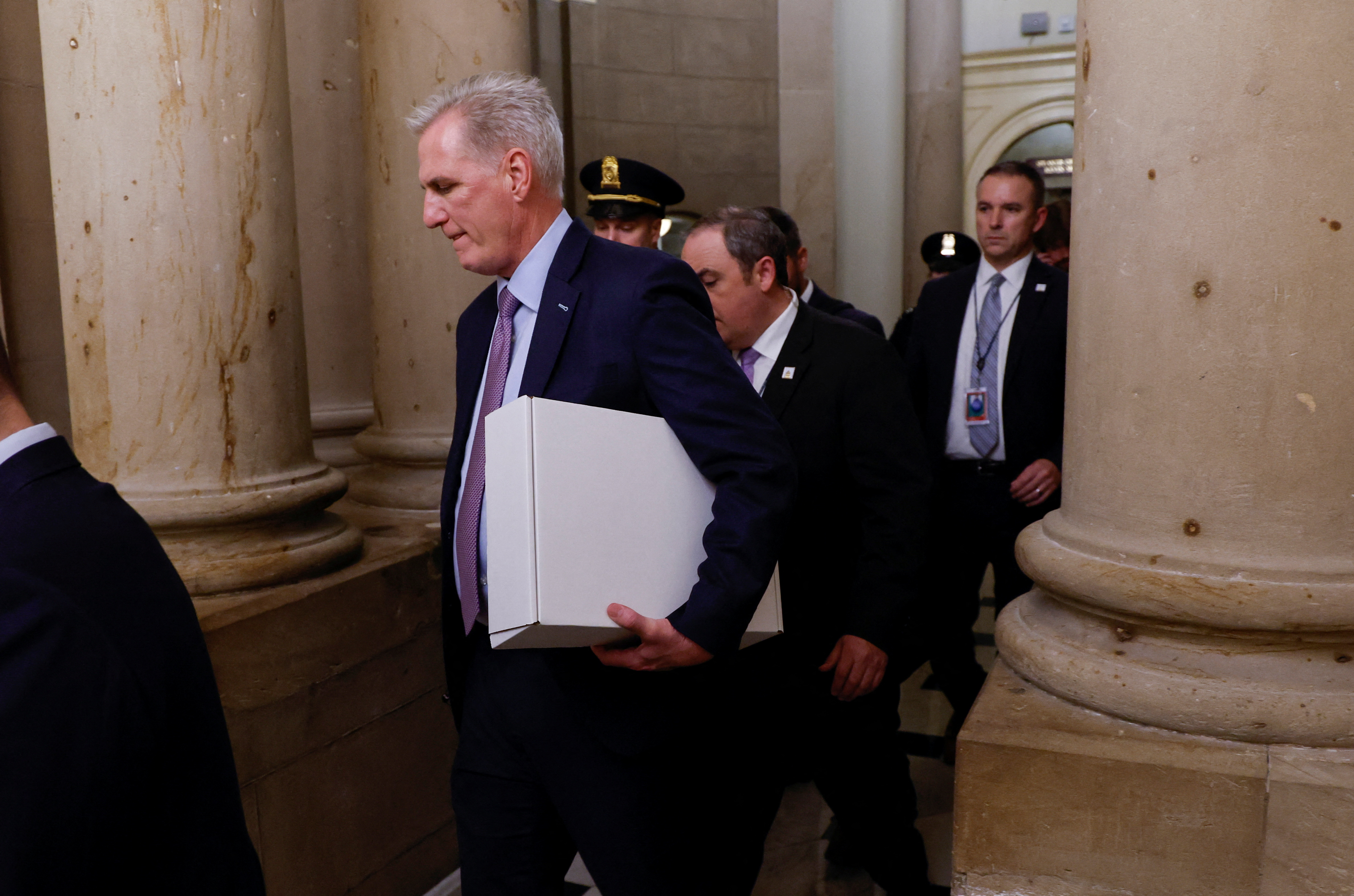 Former Speaker of the House Kevin McCarthy (R-CA) carries a box as he leaves the office of the Speaker of the House and heads out of the U.S. Capitol several hours after being ousted from the position of Speaker by a vote of the House of Representatives on Capitol Hill in Washington, U.S. October 3, 2023. 