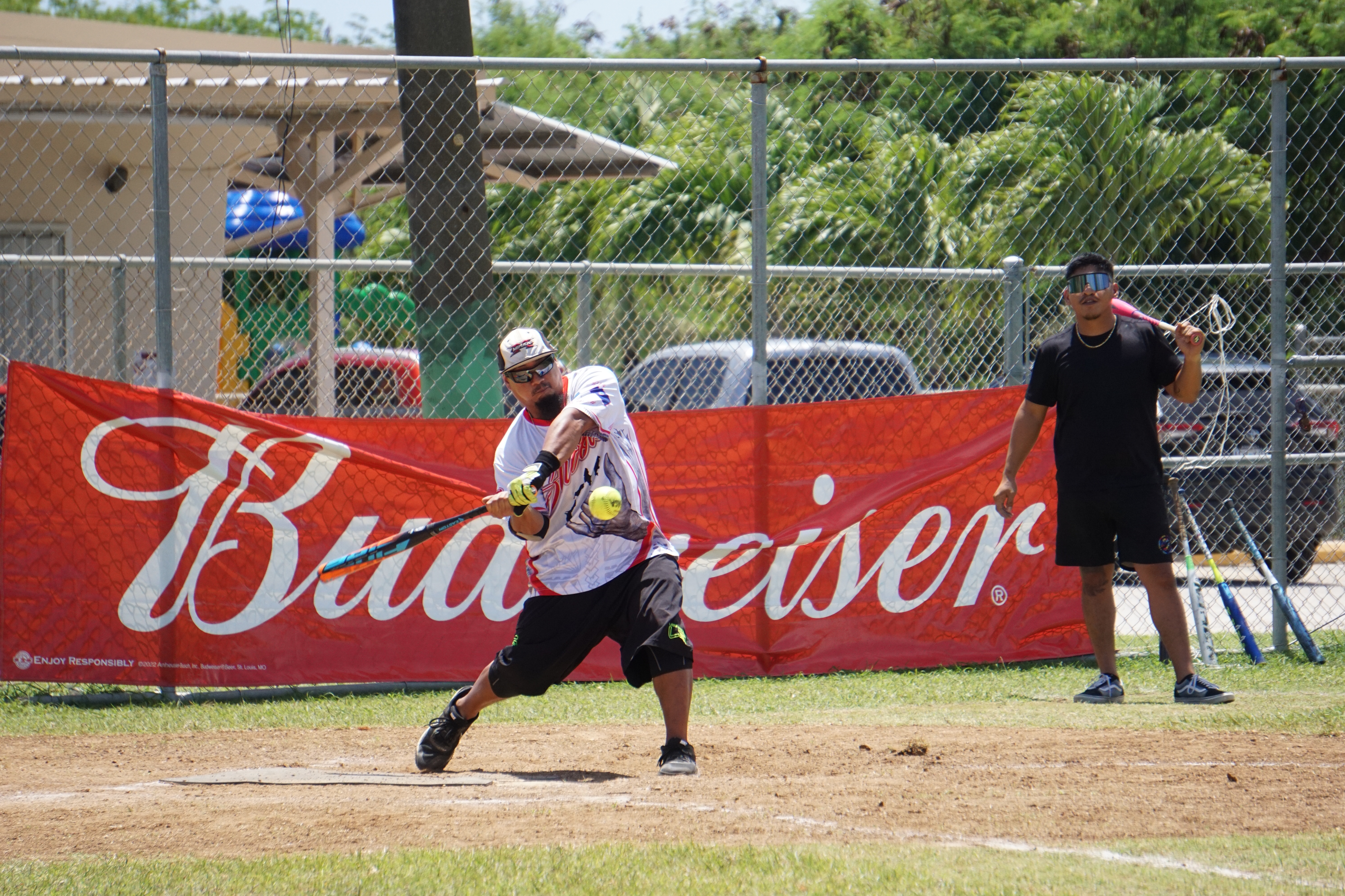 Payday Hao's Mark Villagomez connects a single during a game of the 2023 Budweiser Belau Amateur Softball Association Open League at the Dandan baseball field.