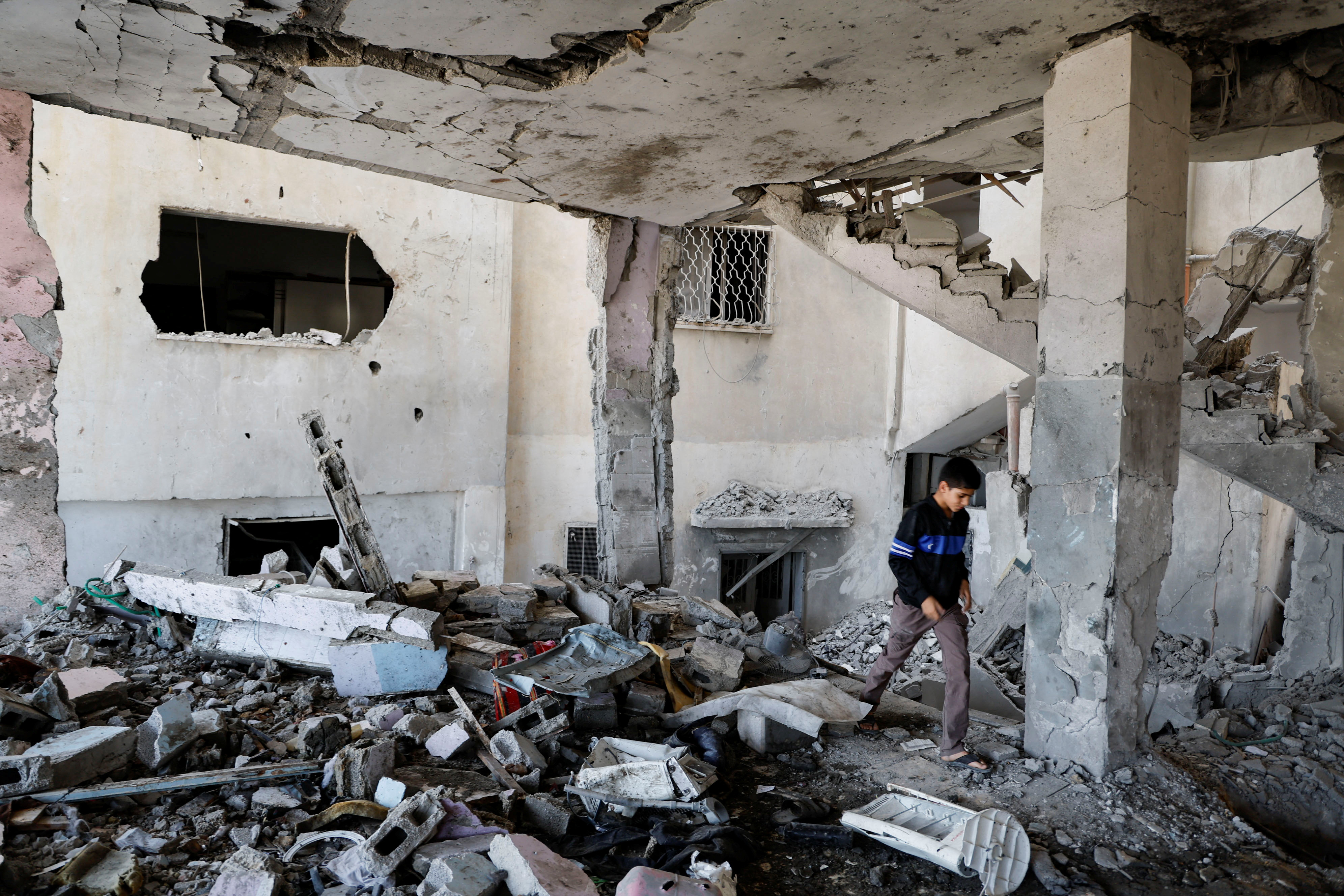 A Palestinian boy checks the damage at a mosque which was hit in an Israeli air strike, in Jenin refugee camp in the Israeli-occupied West Bank October 22, 2023. 