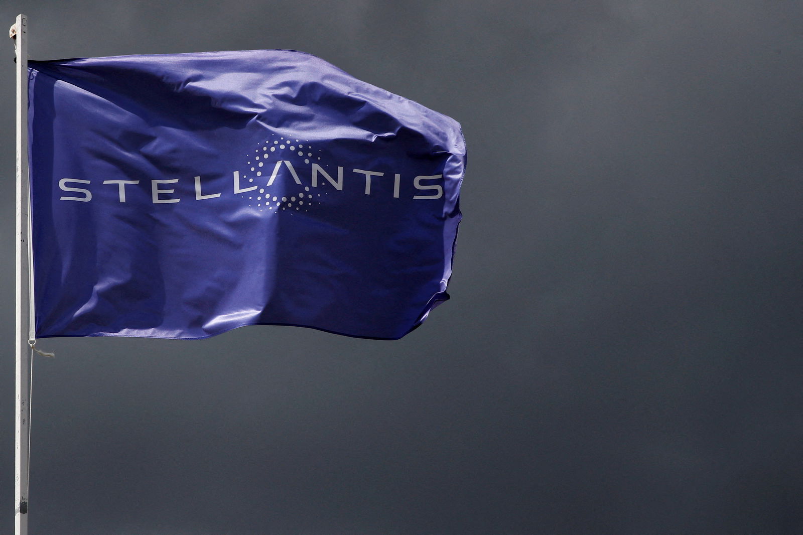 A flag with the logo of Stellantis is seen at the company's corporate office building in Saint-Quentin-en-Yvelines near Paris, France, May 5, 2021. 
