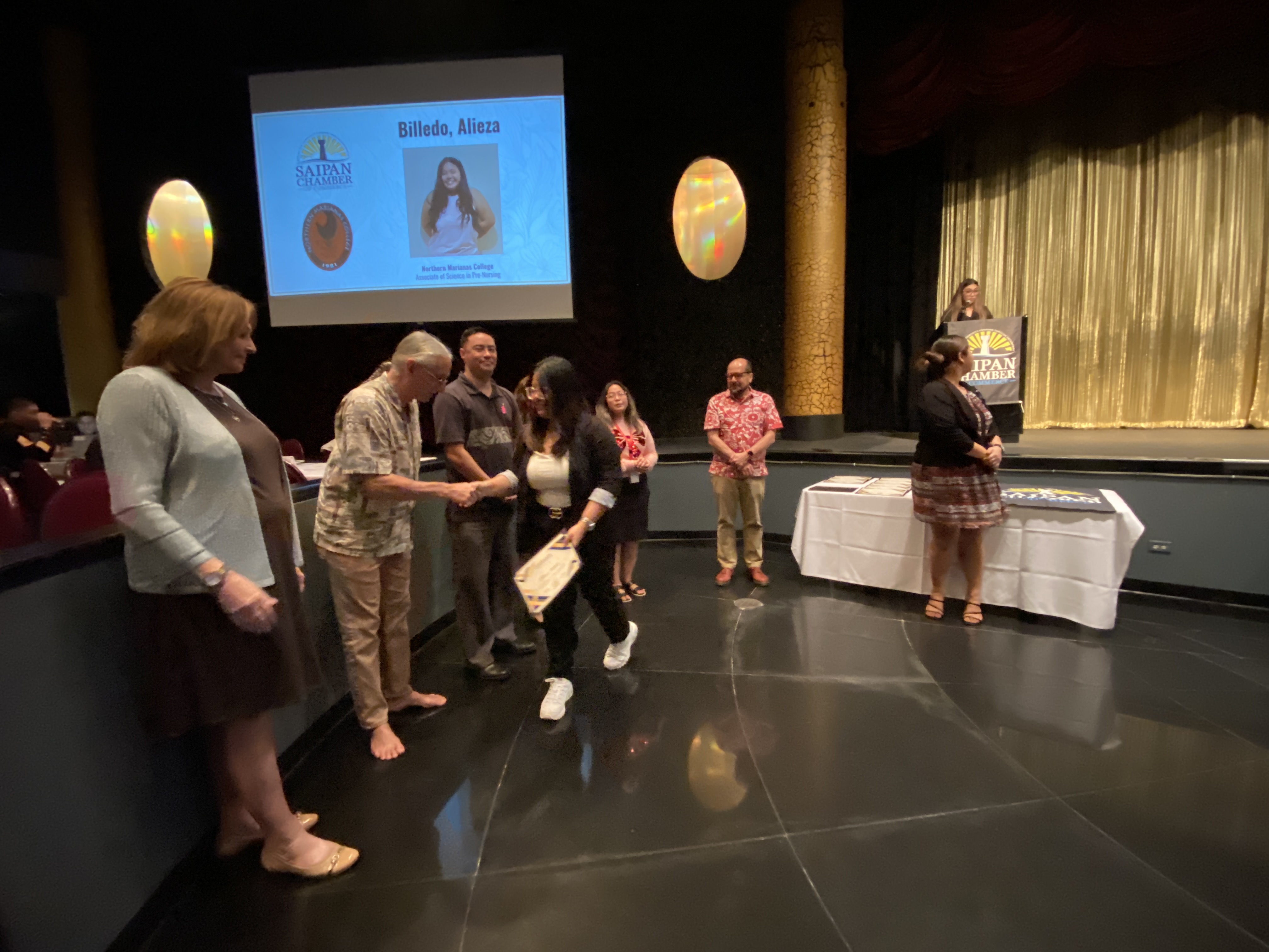 Alieza Billedo shakes hands with Saipan Chamber of Commerce members at their general membership meeting.