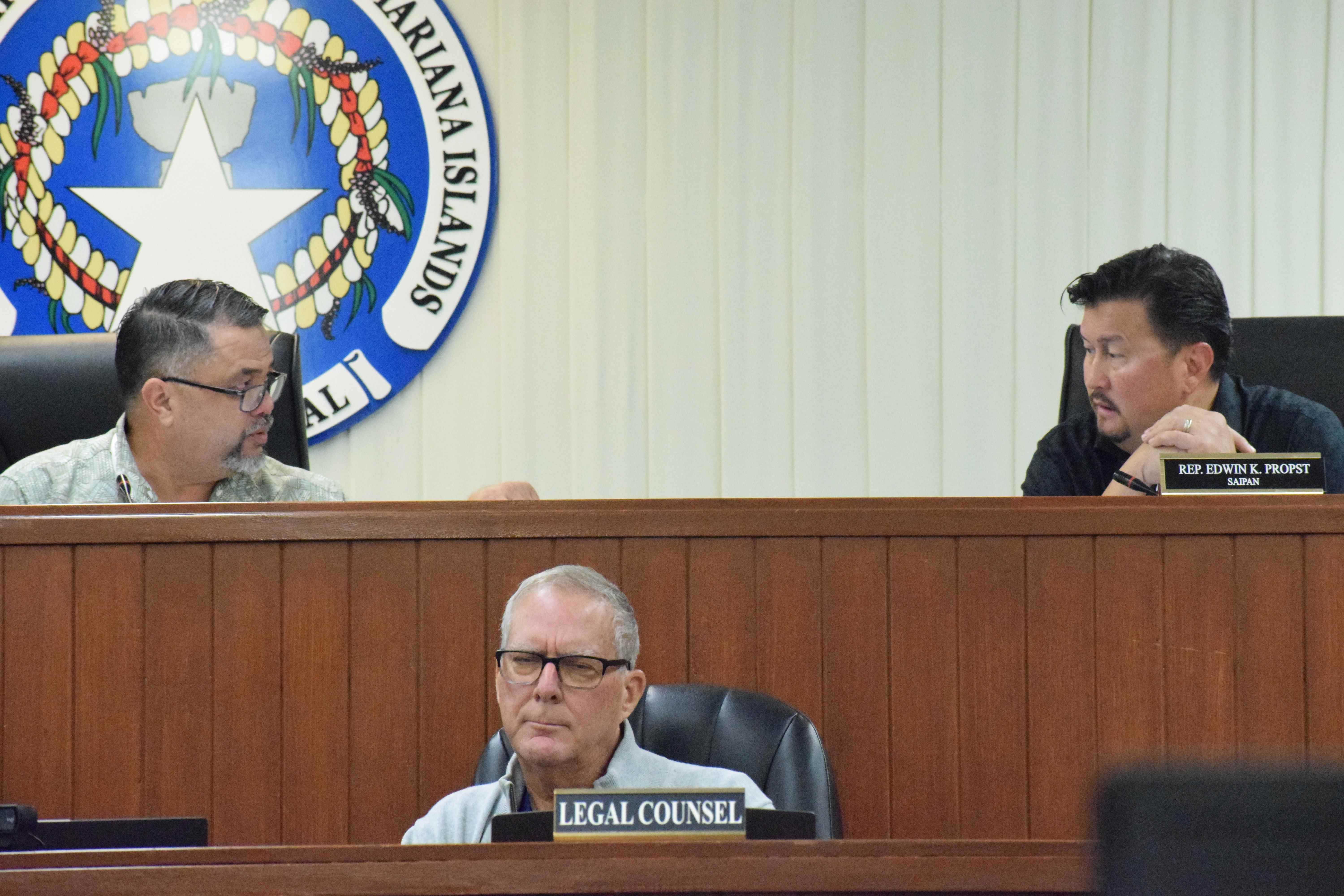 House Special Committee on Federal Assistance and Disaster-Related Funding Chairman Ralph N. Yumul and Vice Chairman Edwin Propst confer during a meeting on Thursday in the House chamber. Also in photo is House legal counsel, John Bradley.