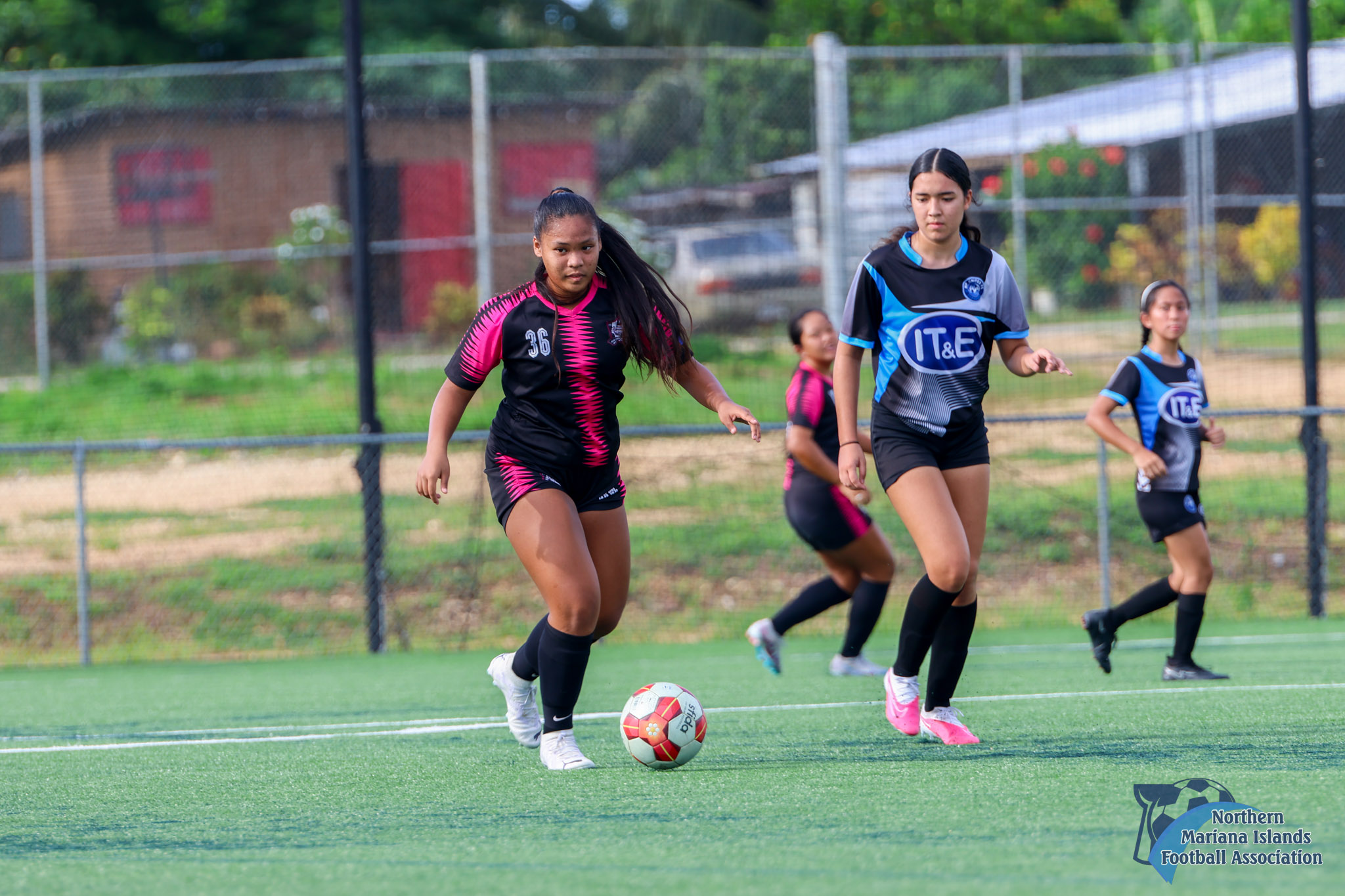 Southern United Football Club's Rizza Relucio dribbles forward as an MPU defender closes in during a U17 girls division game of the TakeCare Youth Soccer League Fall 2023 at the NMI Soccer Training Center in Koblerville.